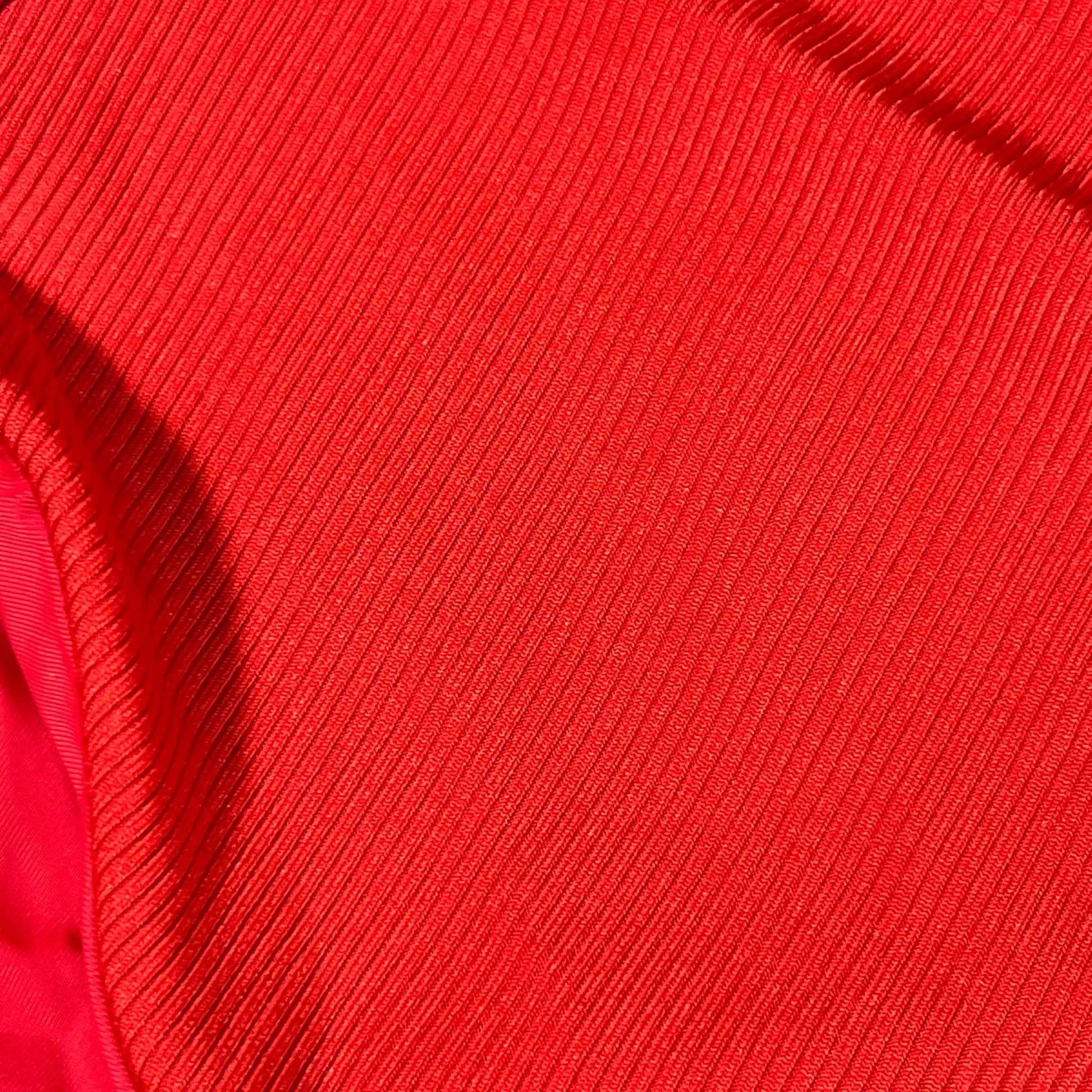 Red ribbed fabric texture of a women's one-shoulder cutout swimsuit in XL size.