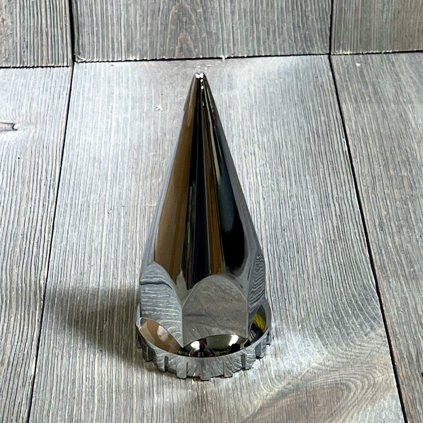 Chrome spike lug nut cover for semi trucks, 33mm x 4 3/4", sleek design, durable plastic, perfect for enhancing wheel appearance.