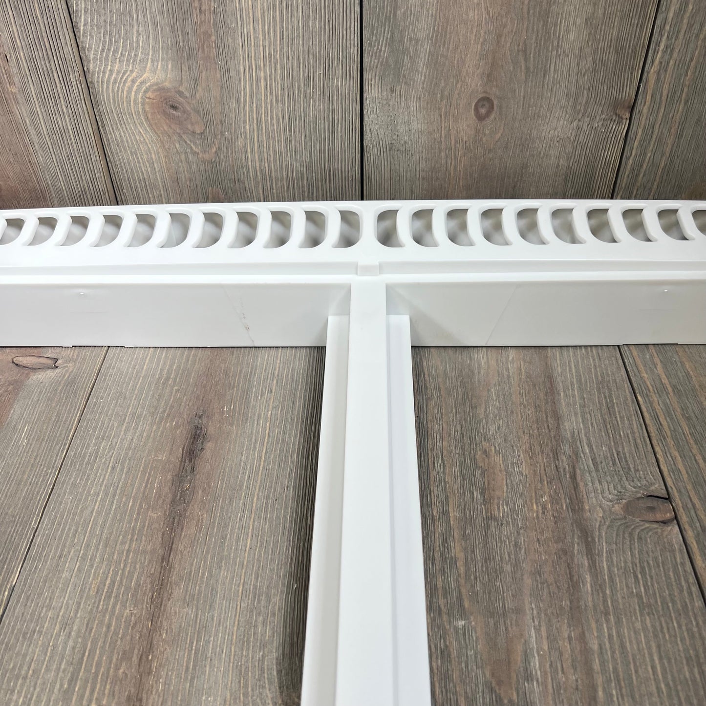 Refrigerator crisper drawer cover frame with vented design, compatible with Frigidaire models, shown on wooden surface.
