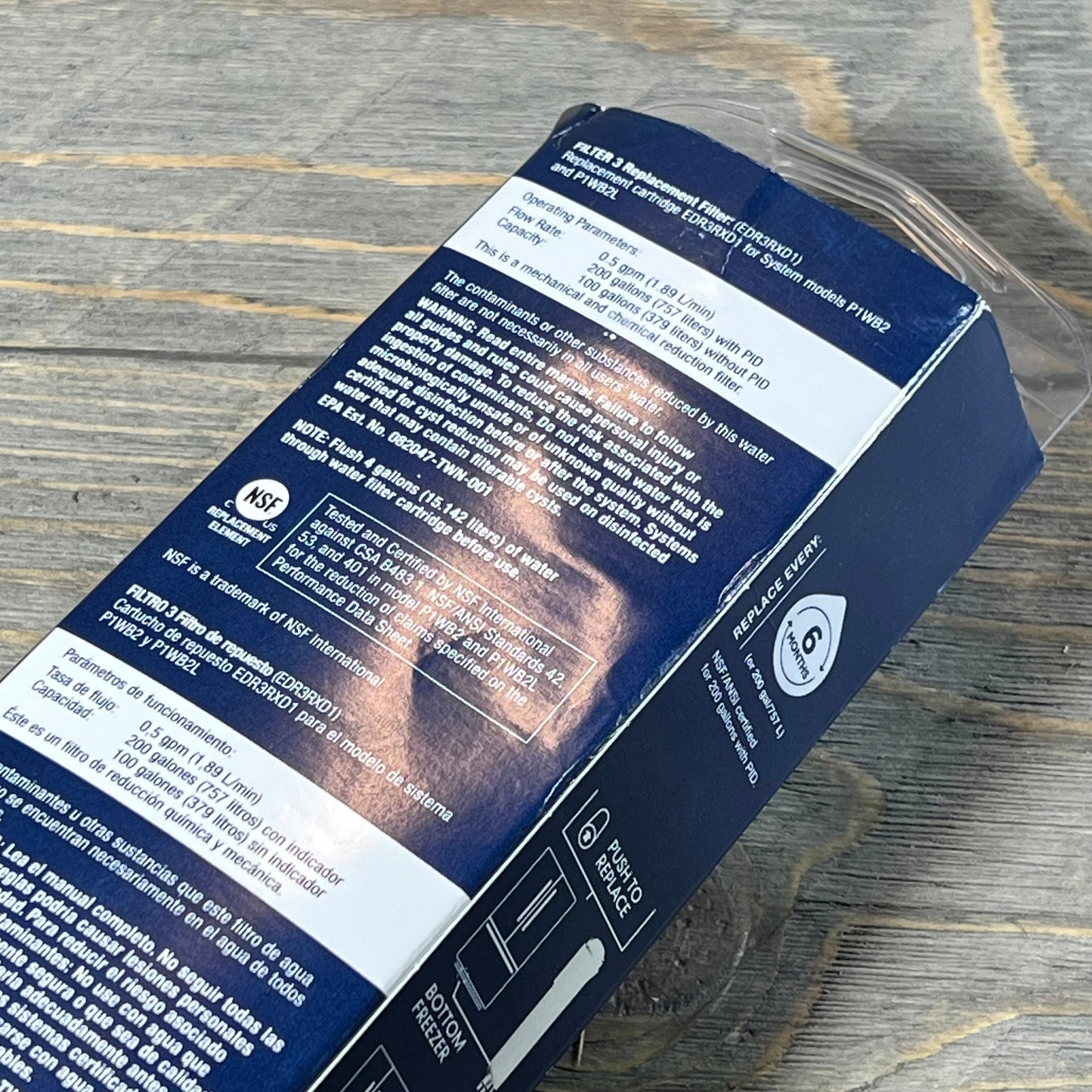 Refrigerator filter packaging with detailed instructions and NSF certification displayed on a wooden surface.
