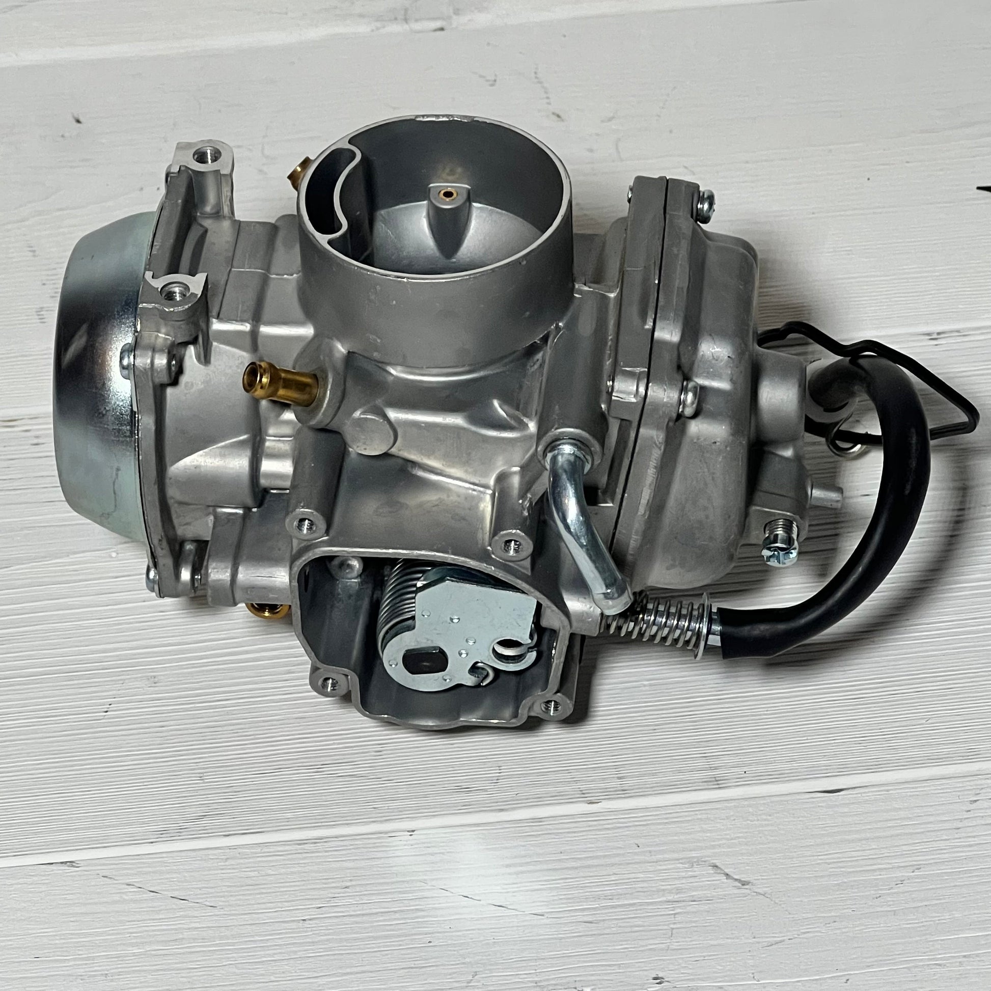 Replacement Caltric Carburetor for Suzuki LT-F250 Quadrunner 250 2X4, showcasing durable metal construction.