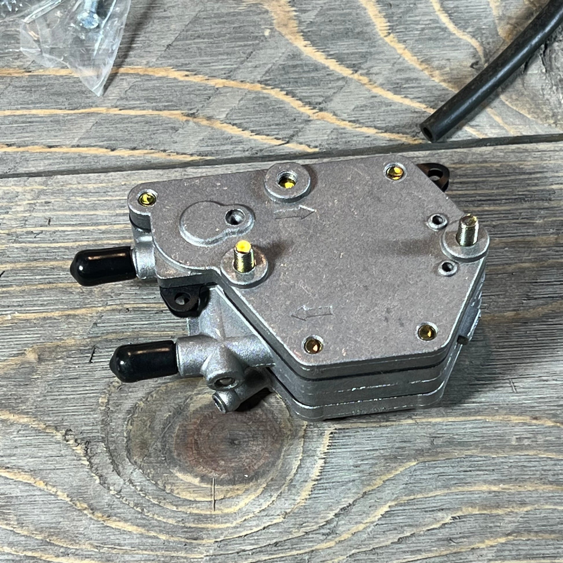 Replacement carburetor for Polaris Sportsman 500, 1996-1998, shown on a wooden surface.