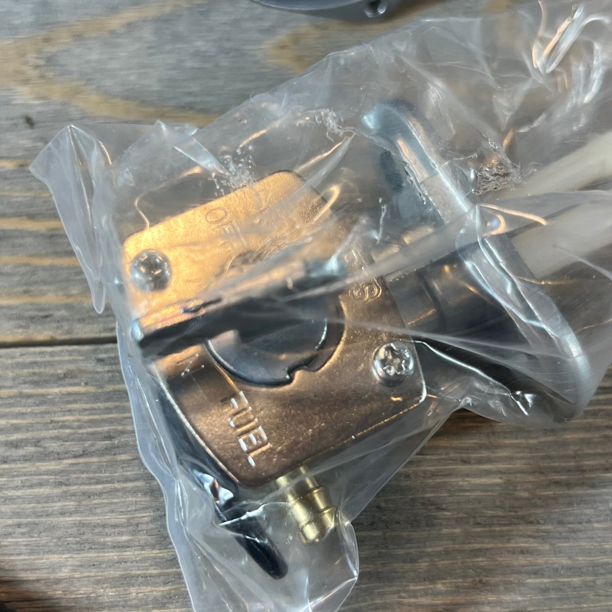 Replacement carburetor petcock for Suzuki LTZ400 Quad 2003-2007, shown in packaging on a wooden surface.