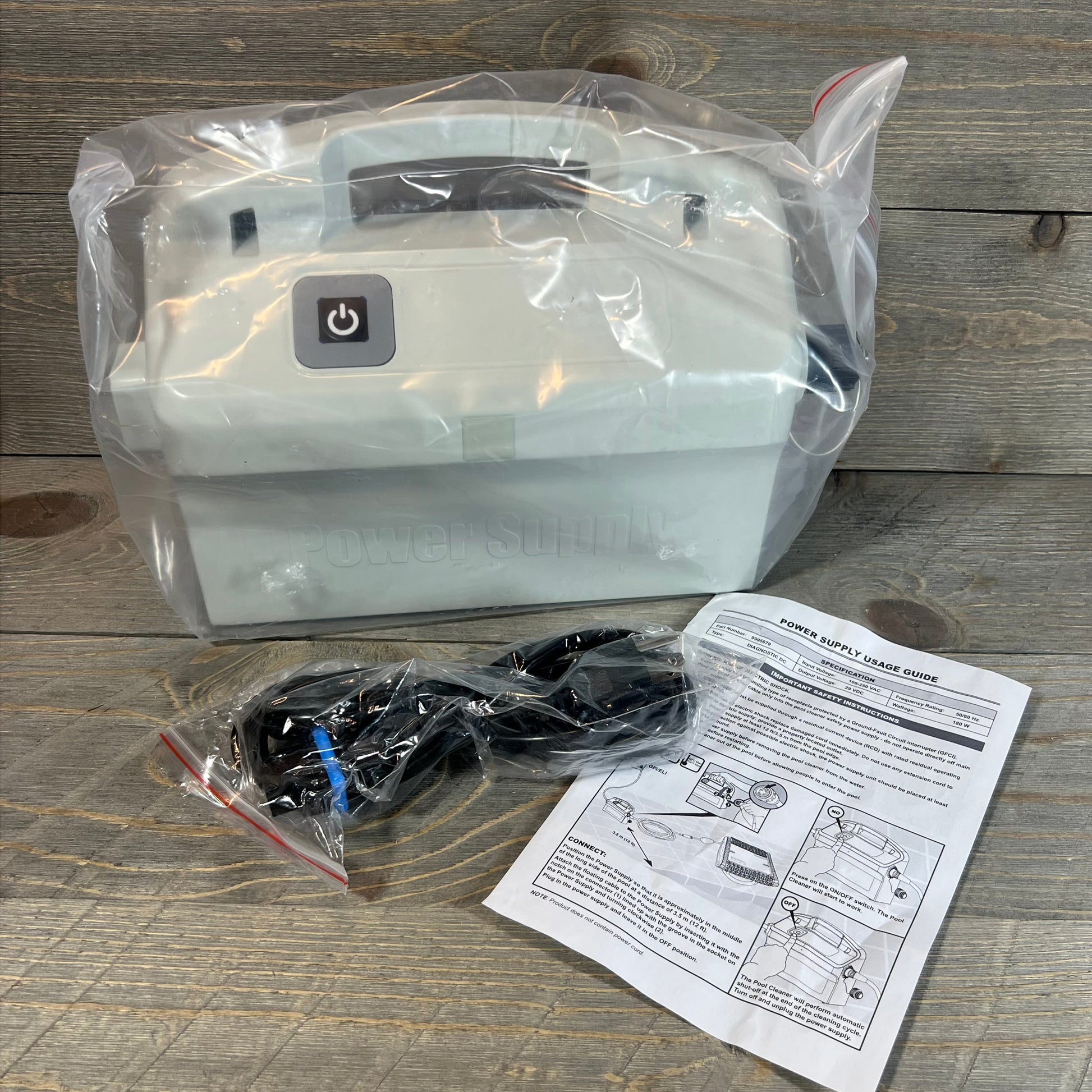 Replacement power supply for Dolphin Diagnostic series, packaged with instructions on a wooden surface.