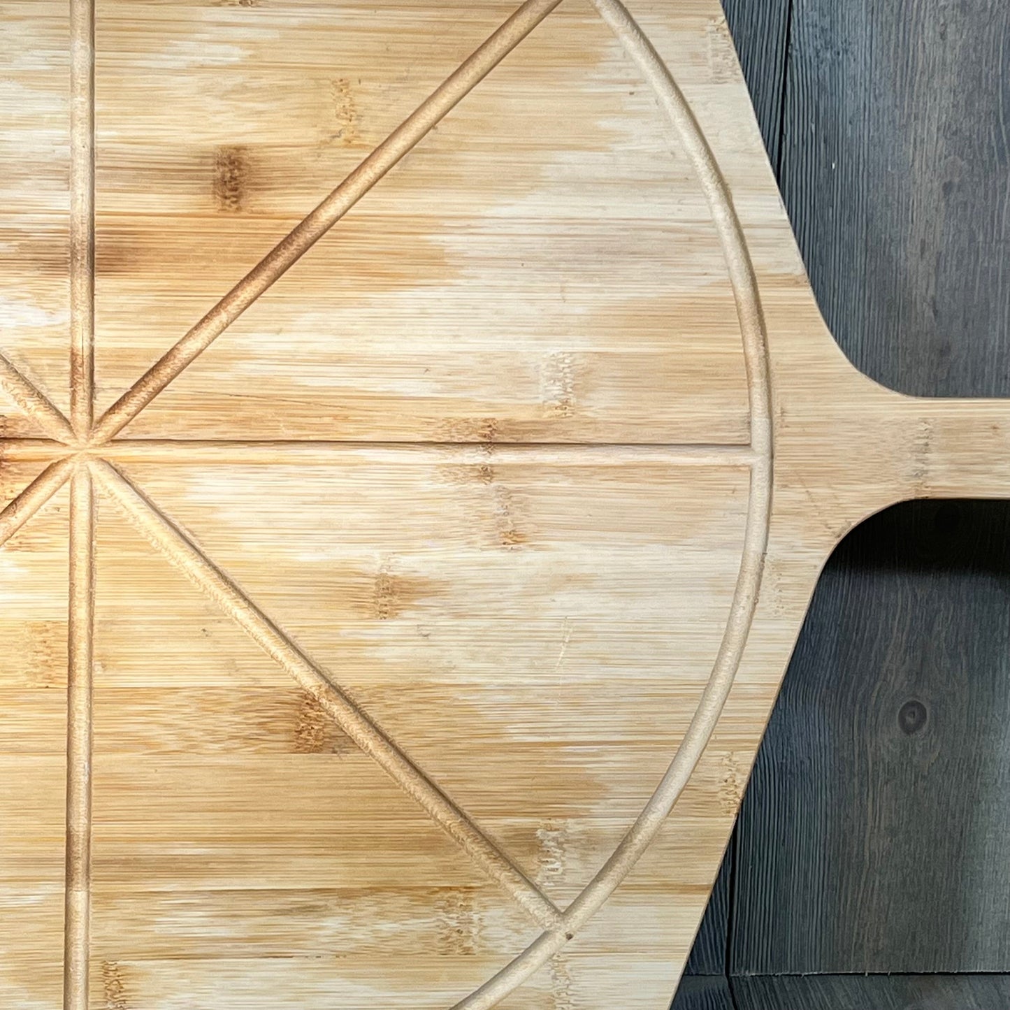 Bamboo pizza peel with 8 slice grooves, perfect for outdoor ovens. Lightweight and smooth, 18" paddle for easy pizza handling.
