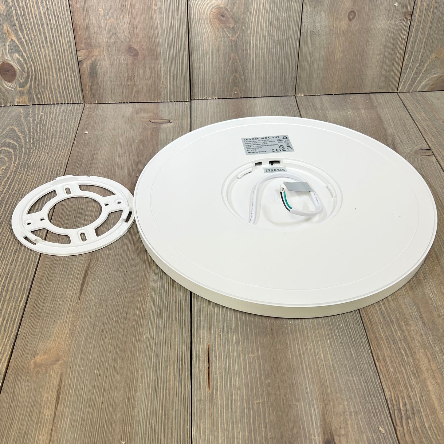 Super slim LED flush mount ceiling light fixture with mounting bracket, showcasing a sleek design and installation components.