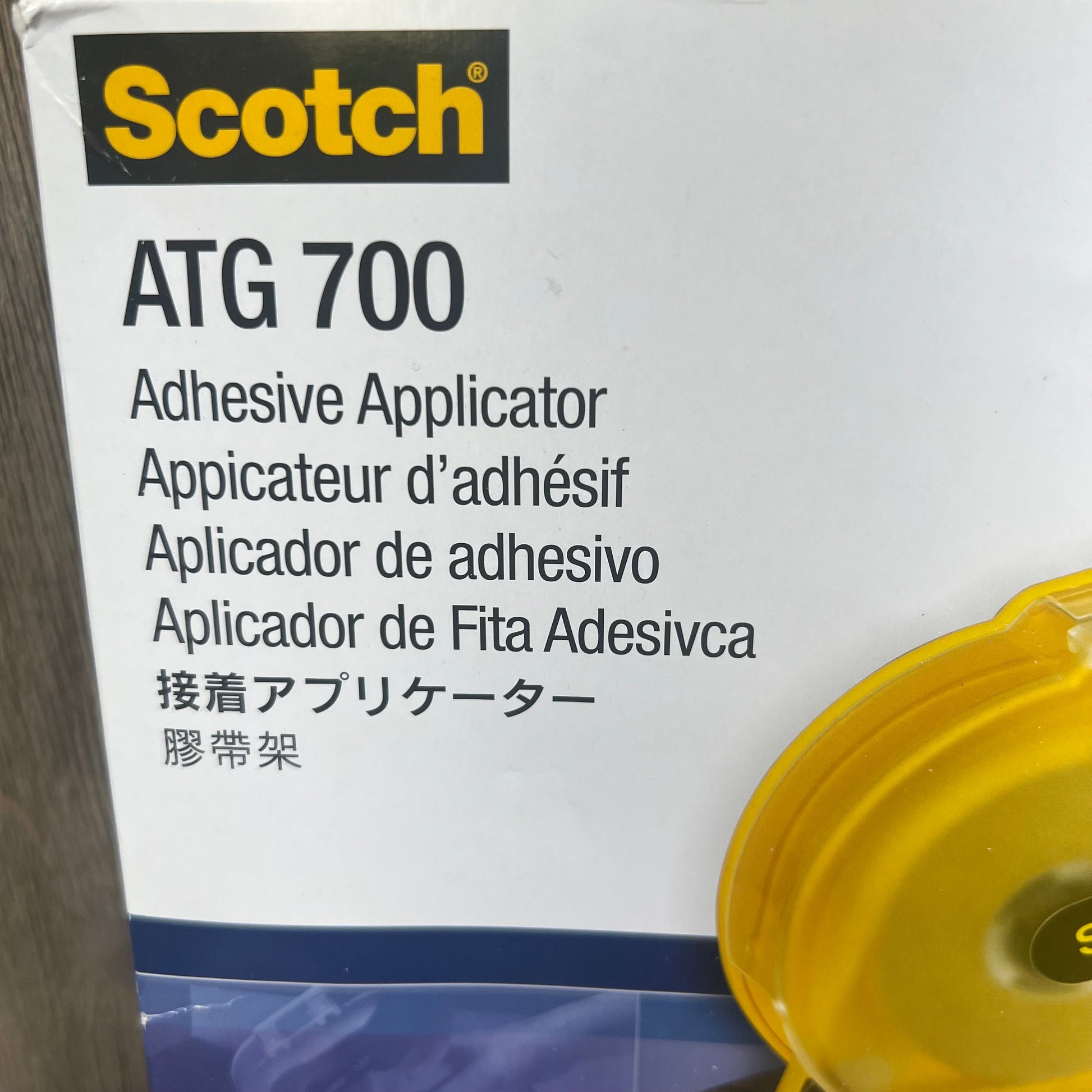 Yellow 3M Scotch ATG 700 Adhesive Applicator box with multilingual text, ideal for 1/2 in and 3/4 in rolls.
