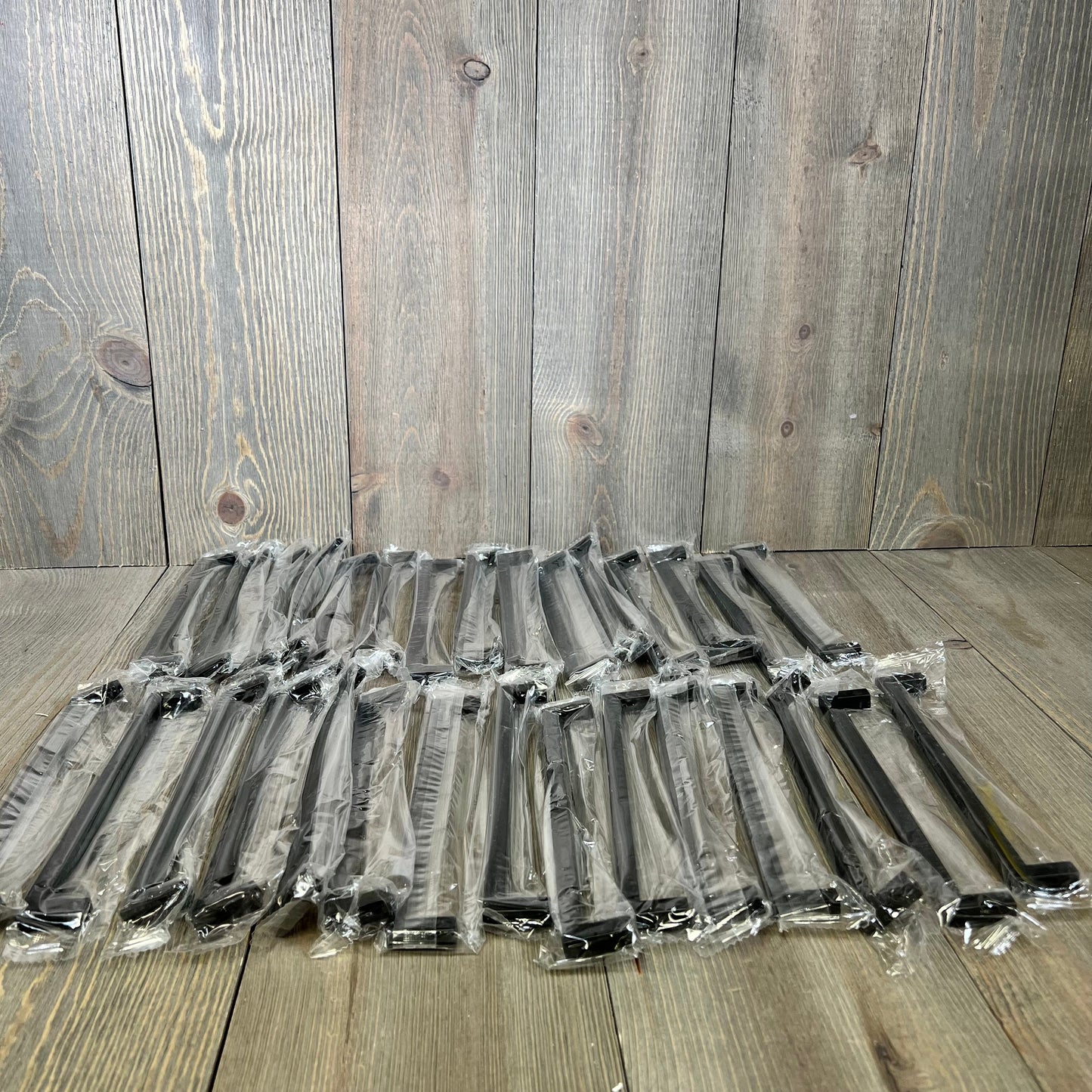 30-pack of Ravinte 7.5-inch matte black square bar drawer handles, individually wrapped, on a wooden surface.