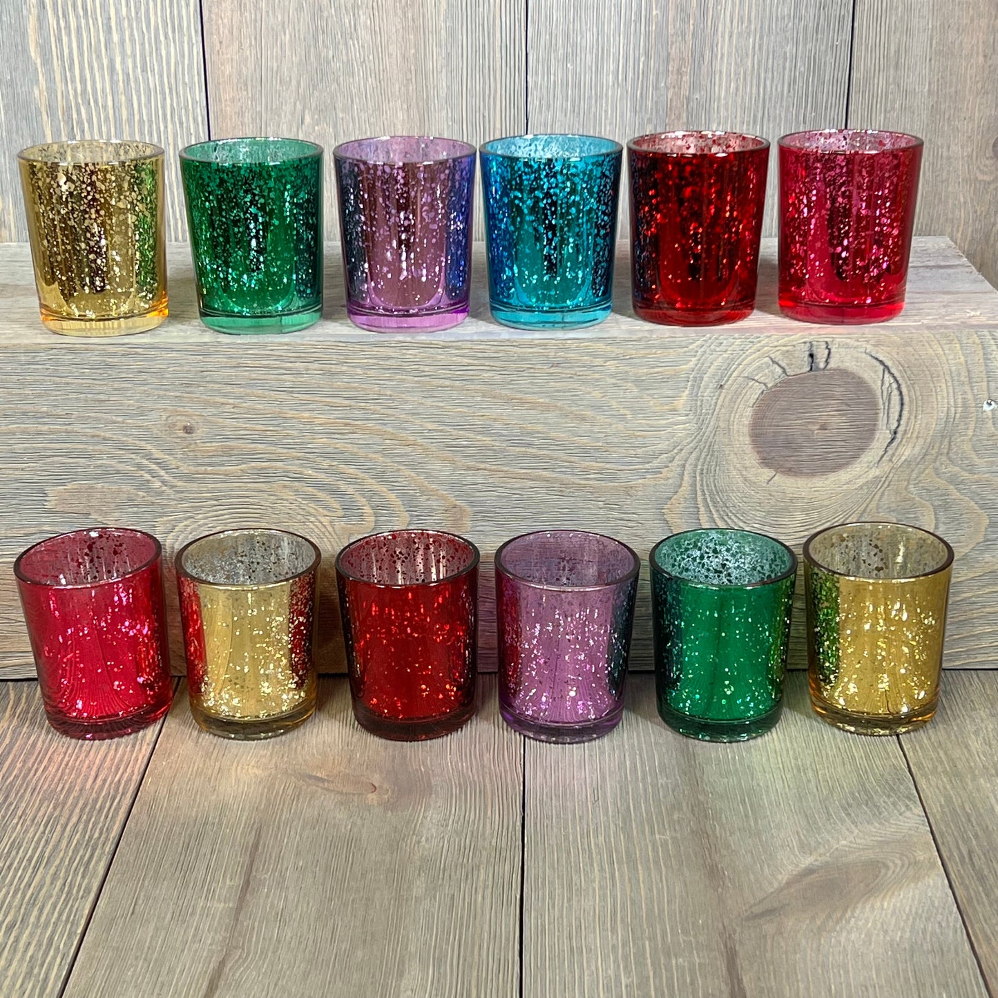 Assorted jewel-tone mercury glass votive candle holders in rich colors, set of 12, ideal for elegant decor.