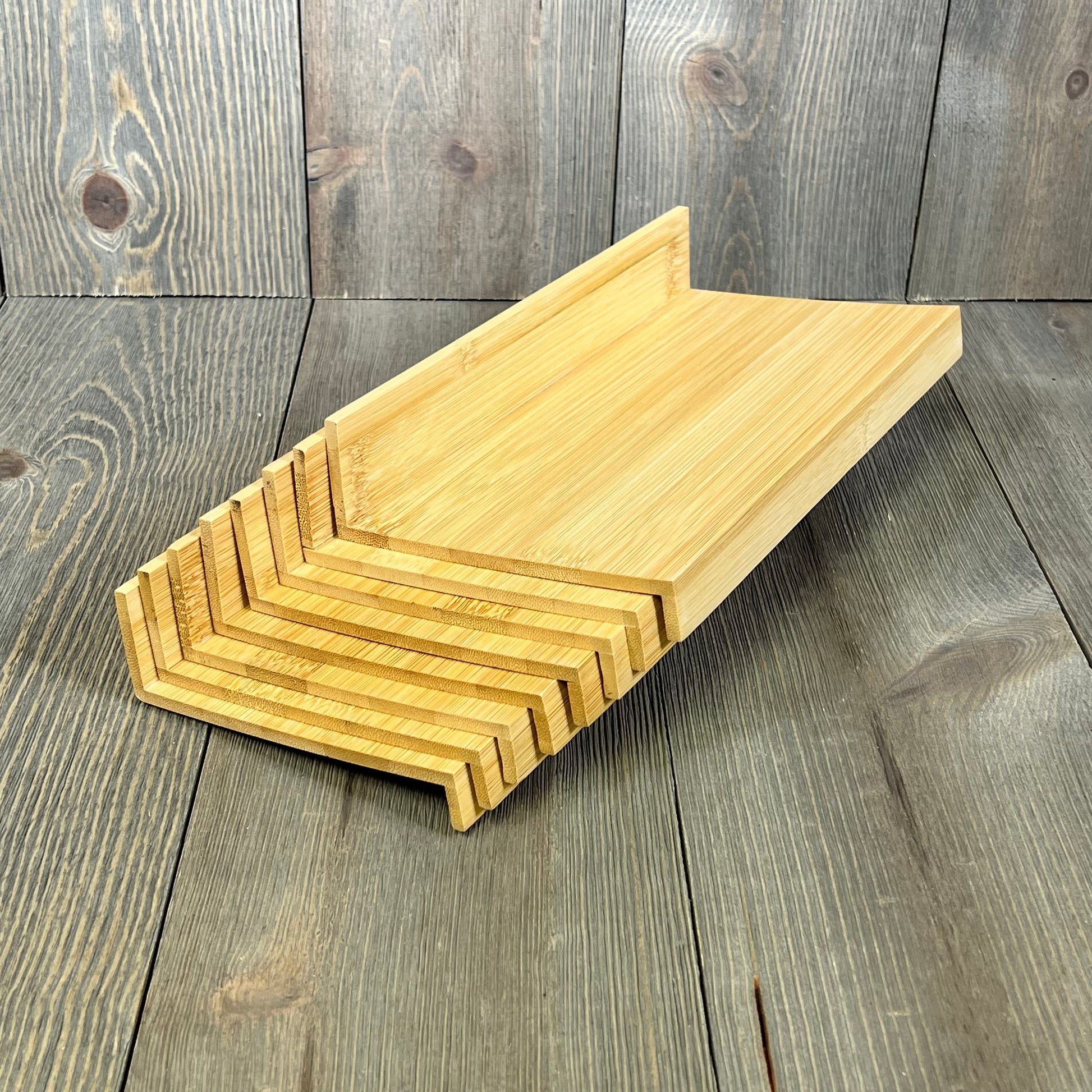 Stackable bamboo spice rack insert for drawers, ideal for organizing kitchen condiments. Eco-friendly and space-saving design.