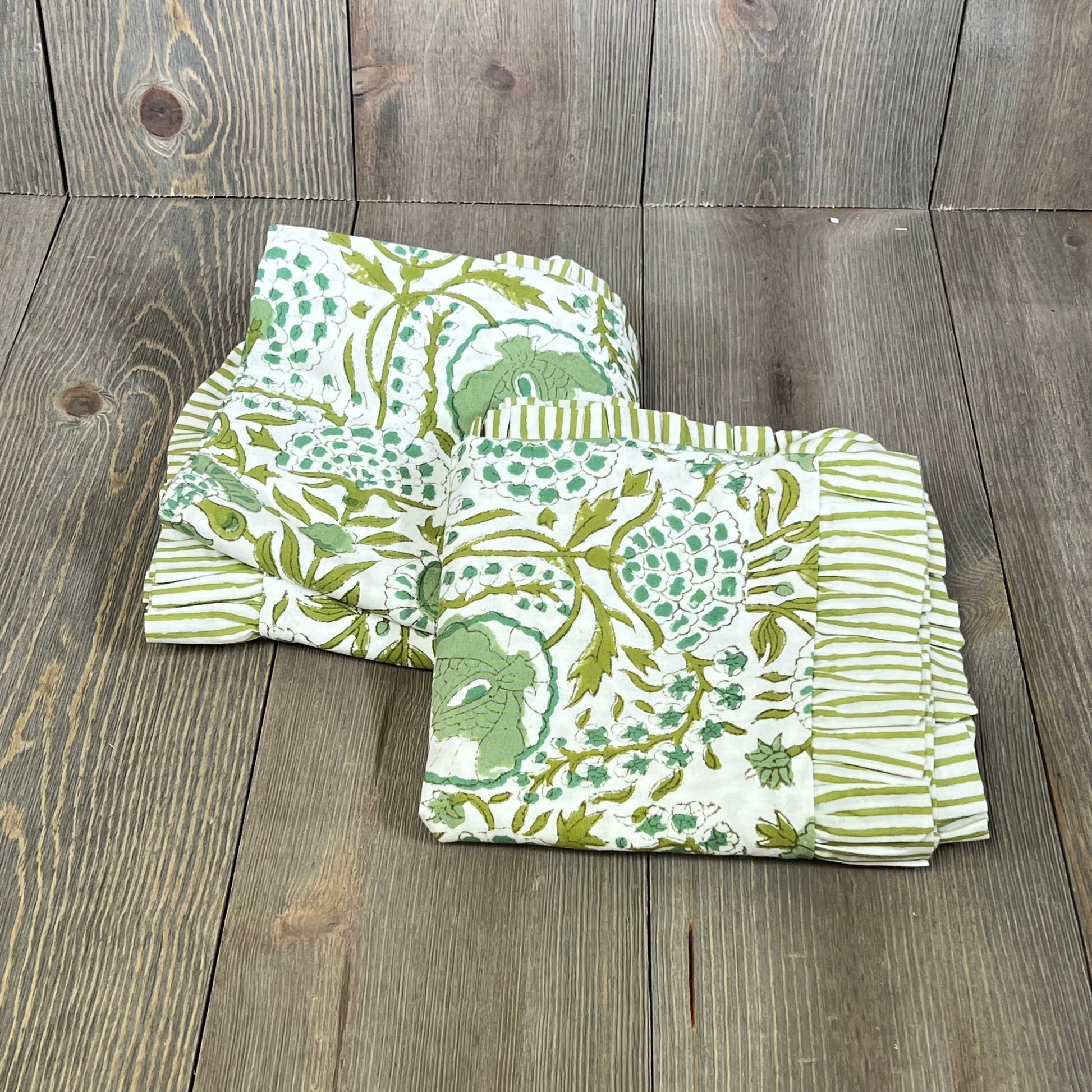 Green and white patterned Agate Green Ruffle Throw Pillow Covers on wooden floor, 24x24 inch, cotton stripe design.