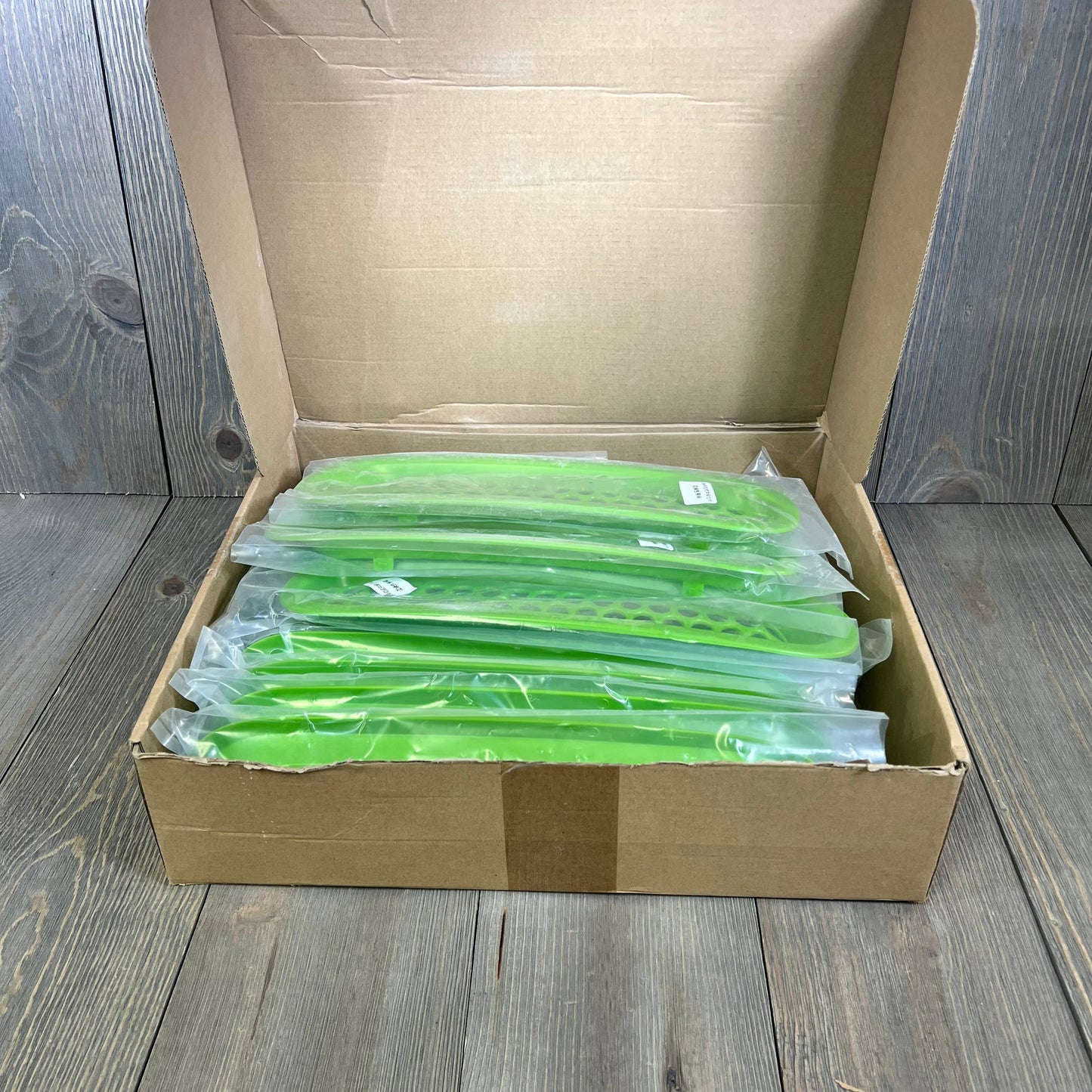 Matte green grille mesh inserts and headlight covers for Jeep Wrangler JK JKU, packaged in a box, ready for installation.