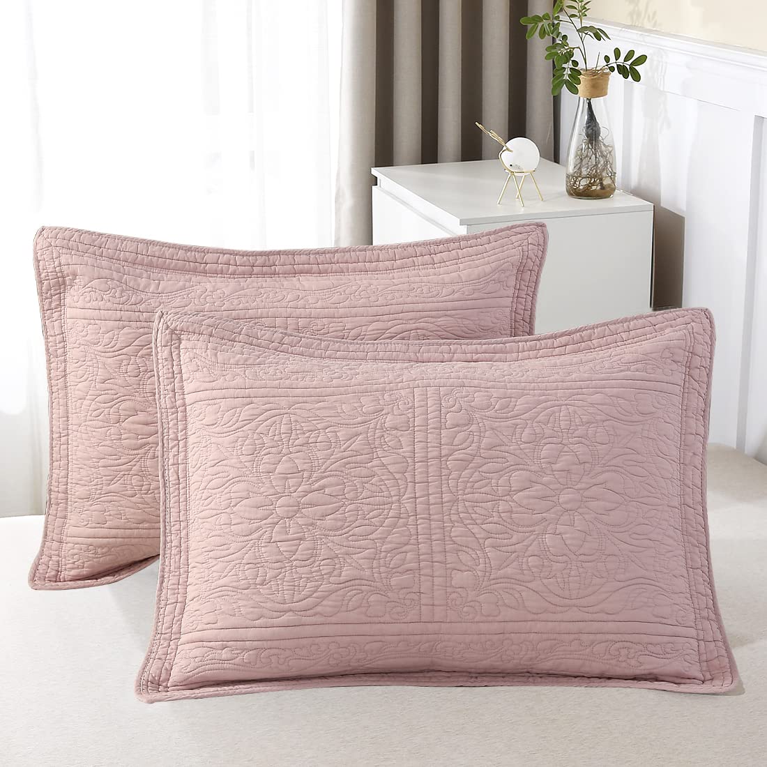Dusty pink floral quilted pillow shams made from 100% cotton, adding elegance and comfort to your bedding ensemble.