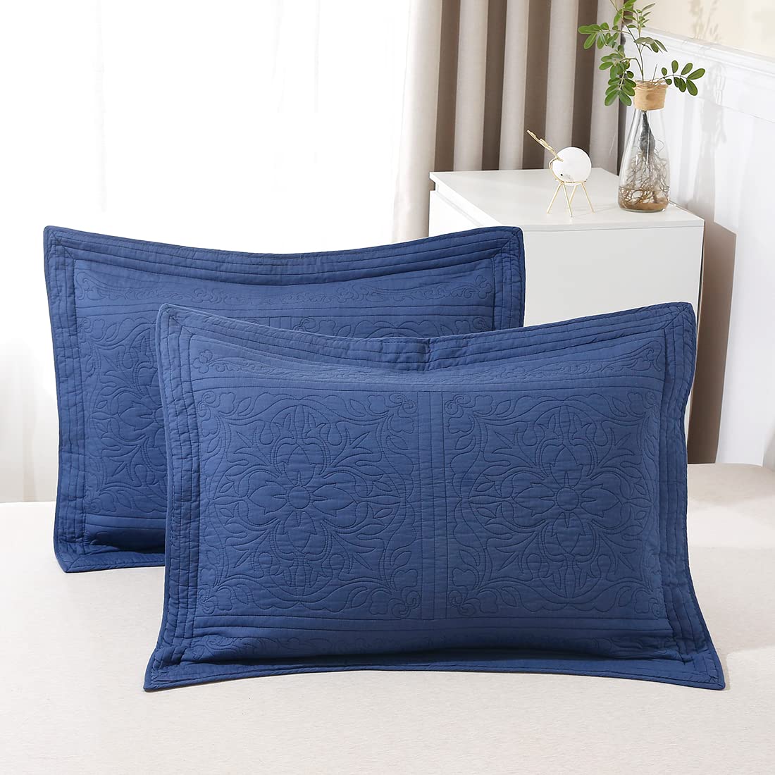 King size navy blue quilted pillow shams with floral design, made of 100% cotton by WINLIFE, on a bed.