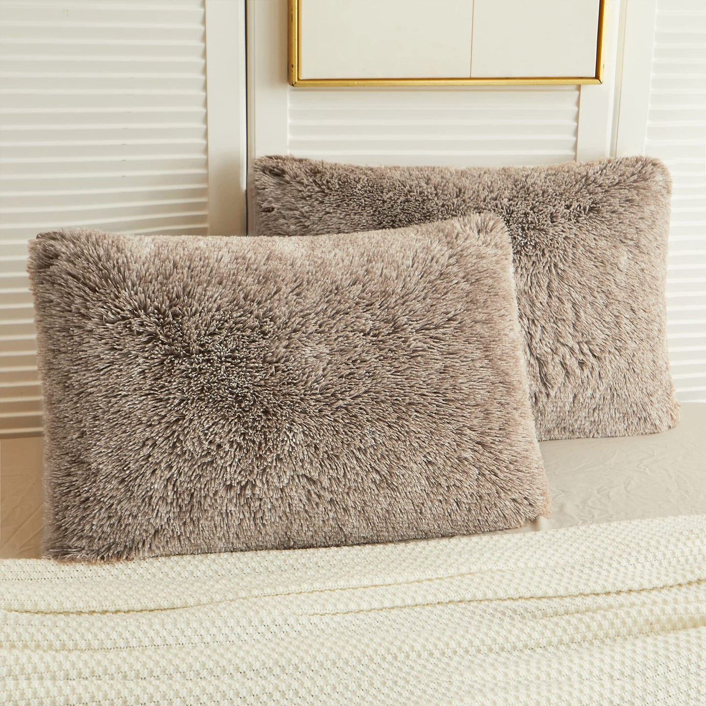 Luxurious ombre khaki faux fur pillow shams on a bed, adding plush comfort and style to your home decor.
