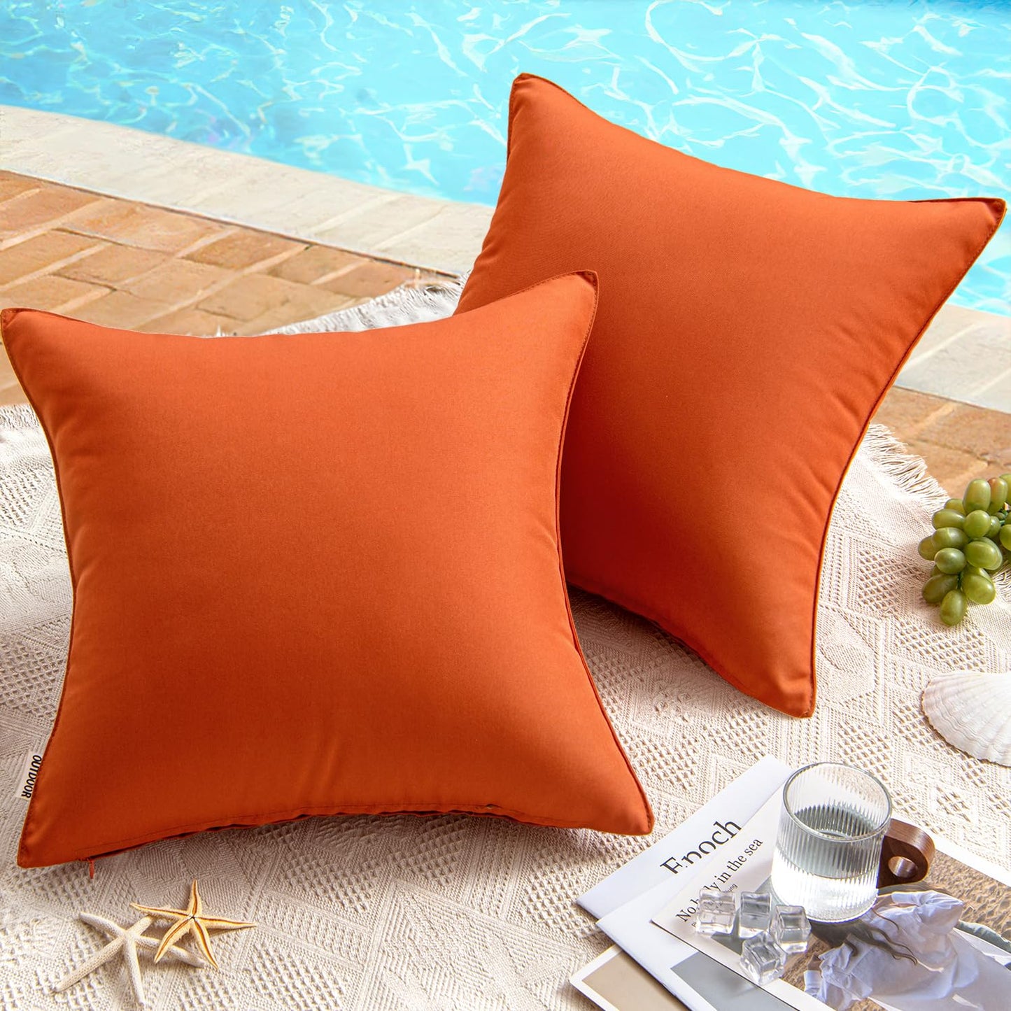 Burnt brick waterproof pillow covers by the pool on a lace cloth, ideal for outdoor patio decor.