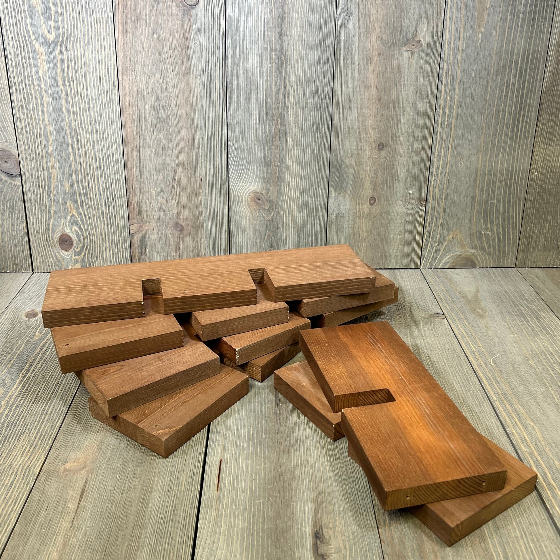 Rustic wood countertop wine rack pieces ready for minimal assembly, designed to hold seven bottles with a natural finish.