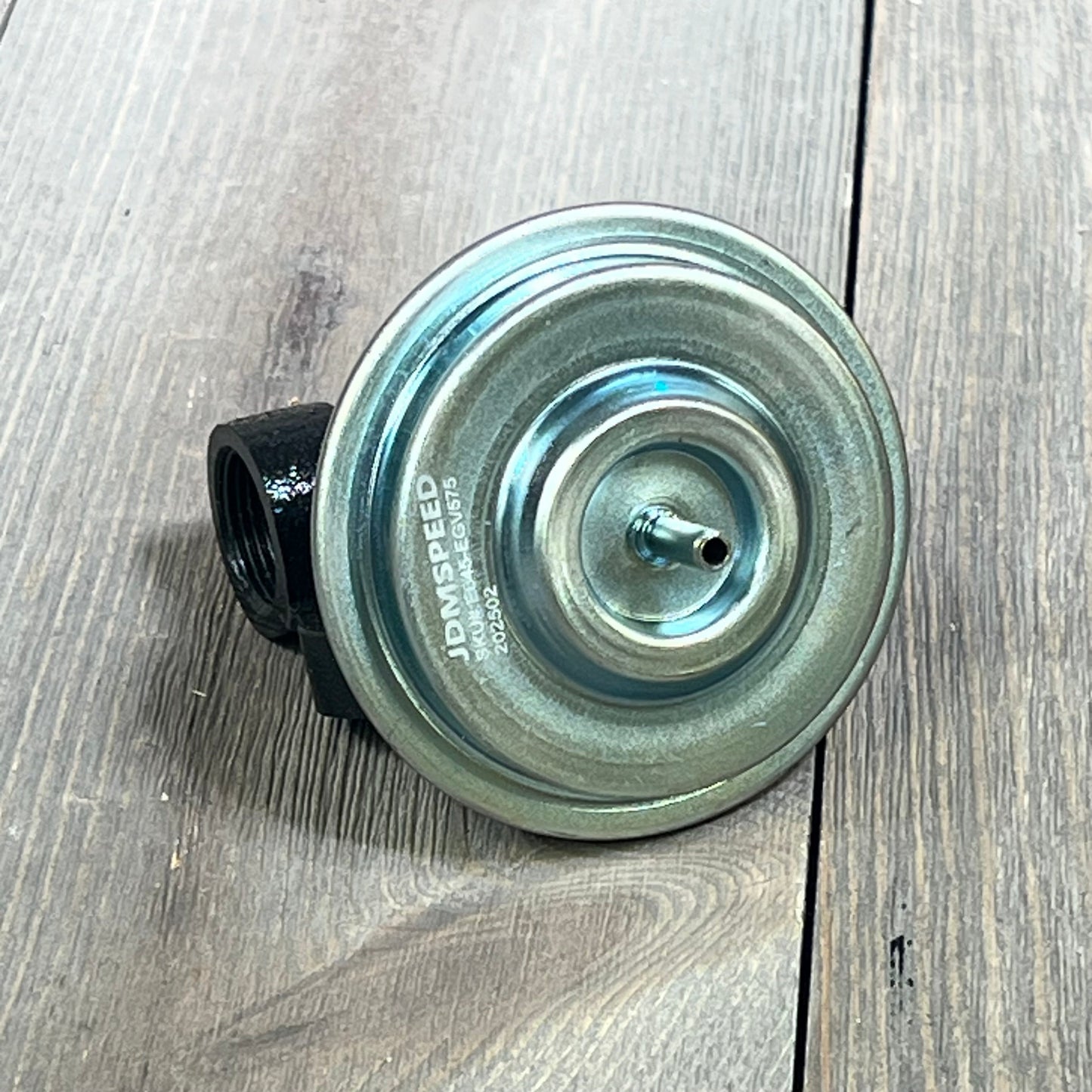 CARMOCAR EGR Valve EGV575 for Ford F-150, durable metal construction, top view on wooden surface.