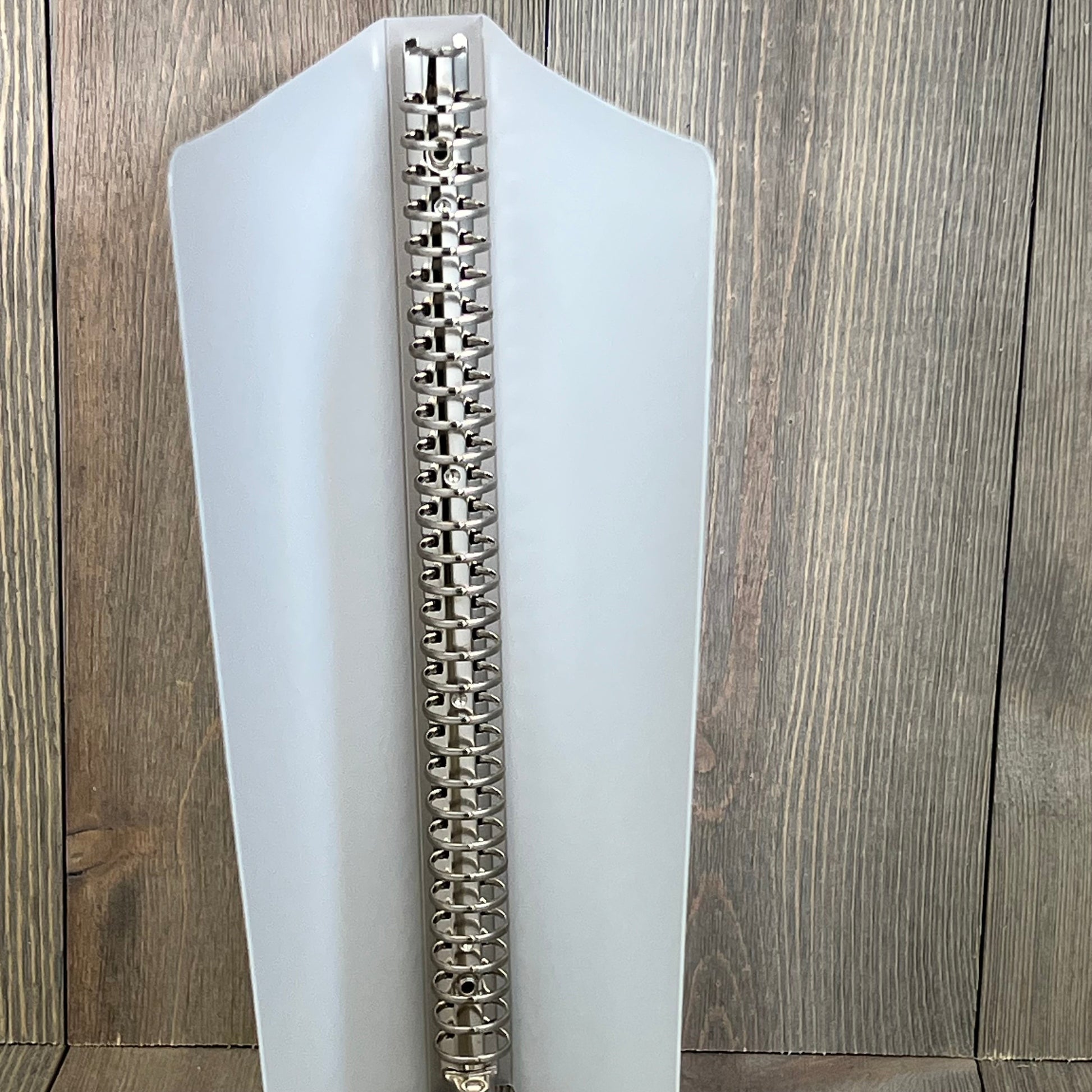 Sturdy spine of 8.5" x 11" recipe book binder, showcasing durable metal rings for secure page holding and easy recipe organization.