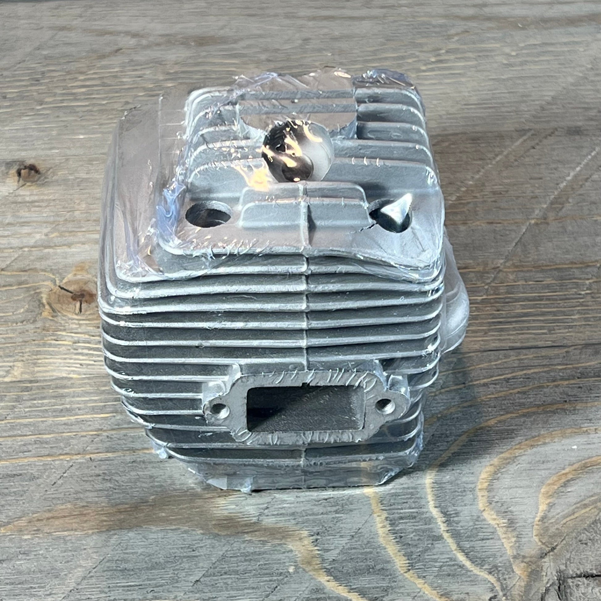 Silver Yingspart 56mm cylinder piston kit for Stihl TS700 TS800 on wooden background.