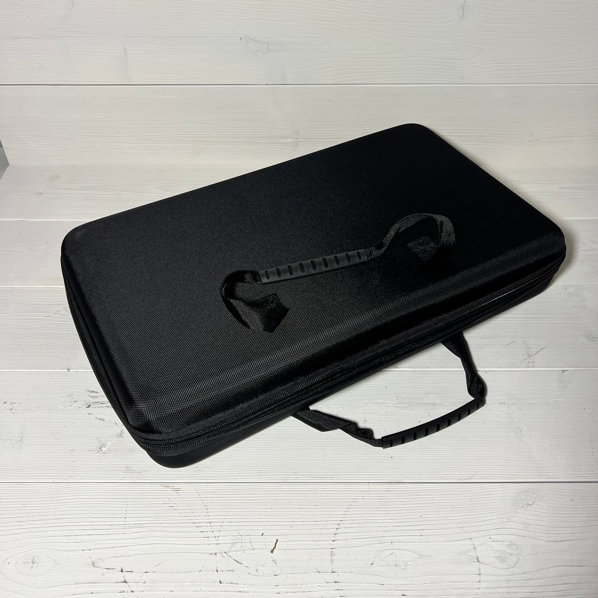 Sleek black Brappo miniature carrying case with durable handle, perfect for storing gaming figures securely.