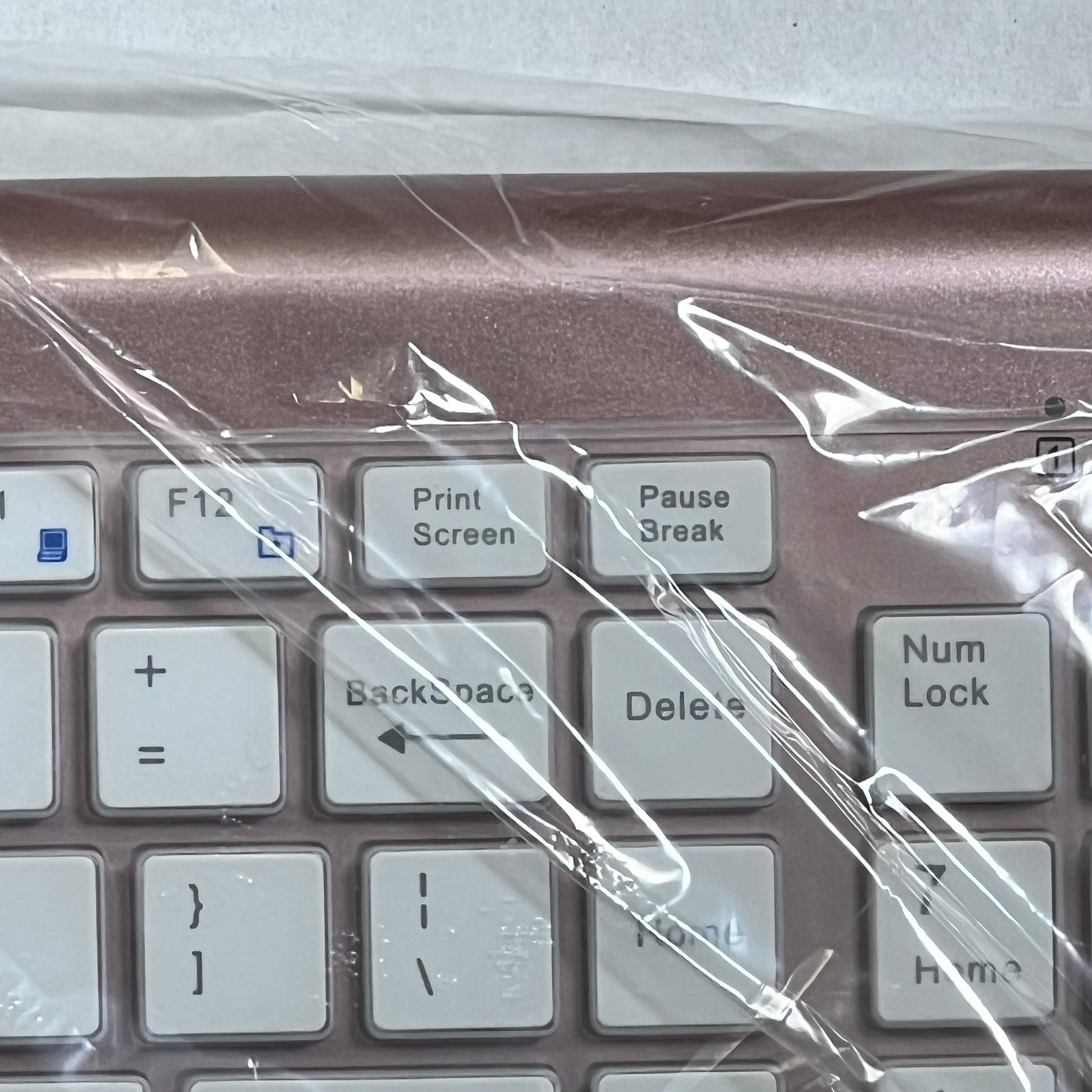 Rose gold wireless keyboard close-up, featuring scissor switch keys and sleek design, perfect for PC and Mac use.