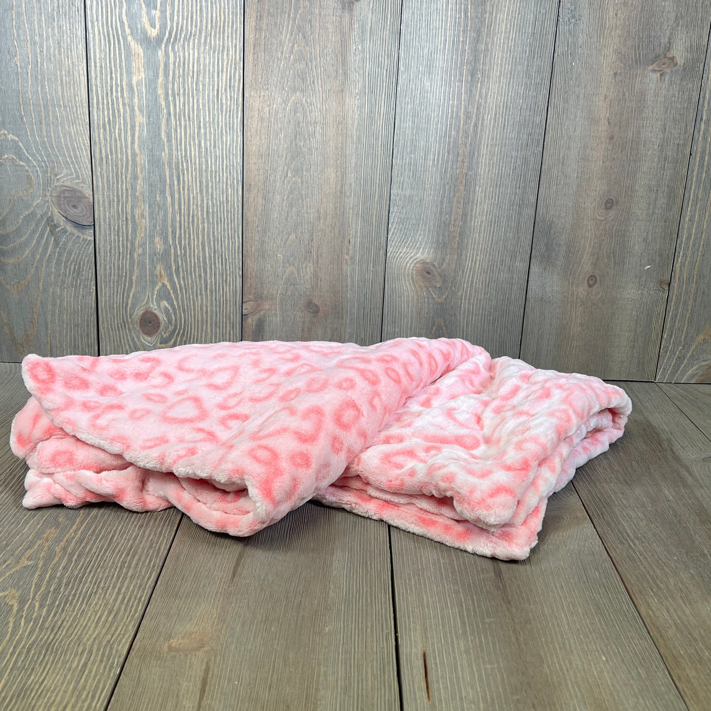 Pink leopard print flannel fleece pillow covers on wooden surface, perfect for sofa or bed, 20 x 20 inches, set of 2.