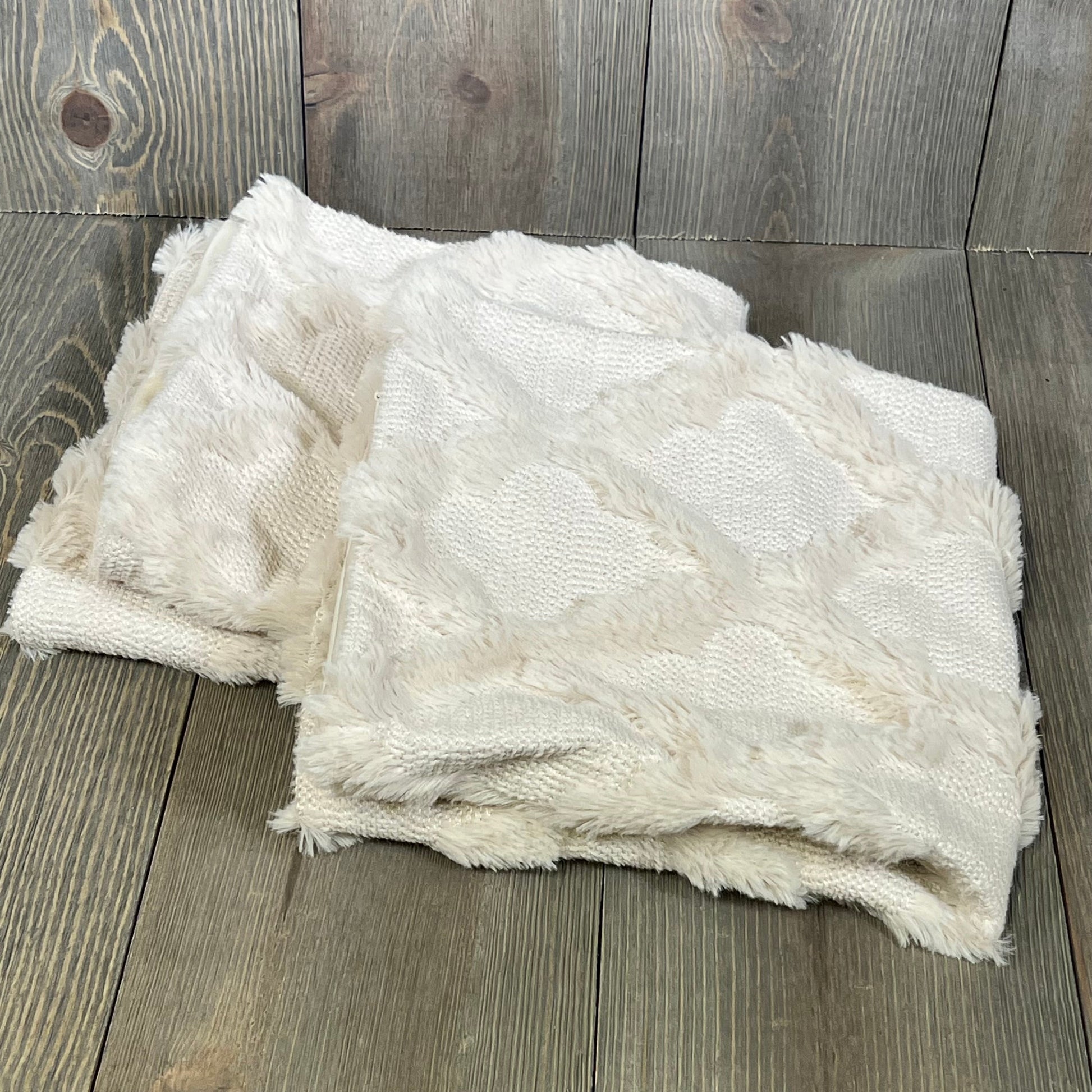 Fluffy beige Moroccan pillow covers, 18x18 inches, add boho charm to bed or sofa with plush texture.