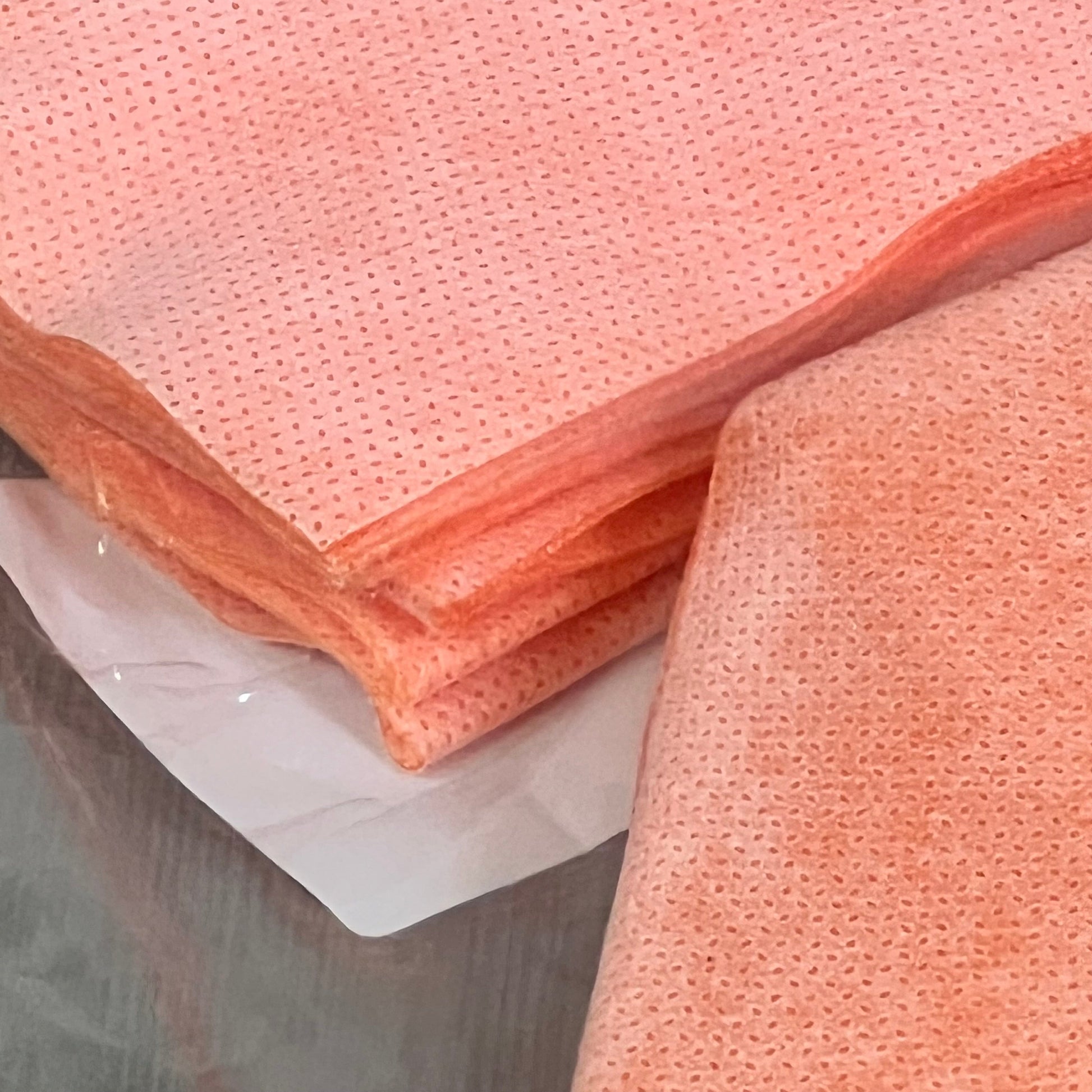Orange polyethylene seamless corner covers for waterproofing, ideal for bathtubs and steam rooms, shown in close-up.