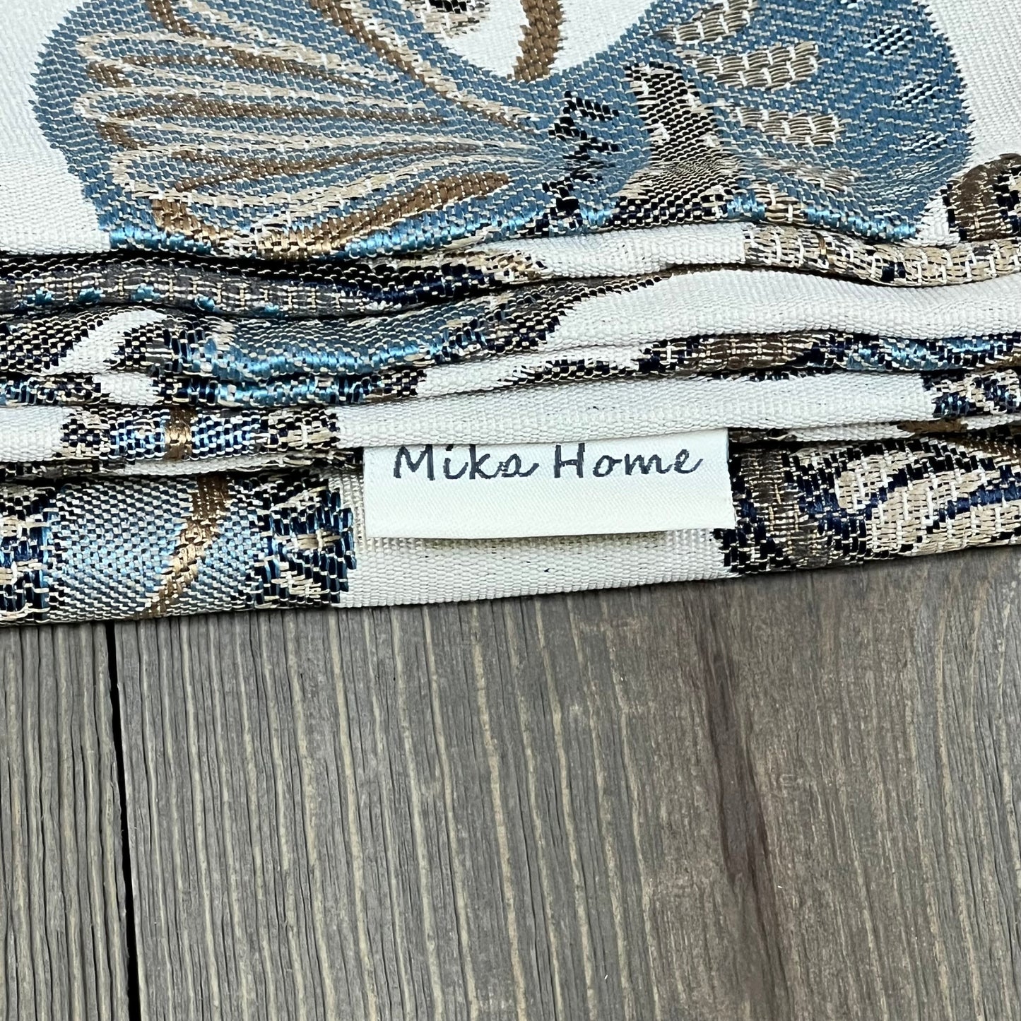 Blue cream jacquard tropical leaf pillow covers by Mika Home, showing detailed texture and elegant design.