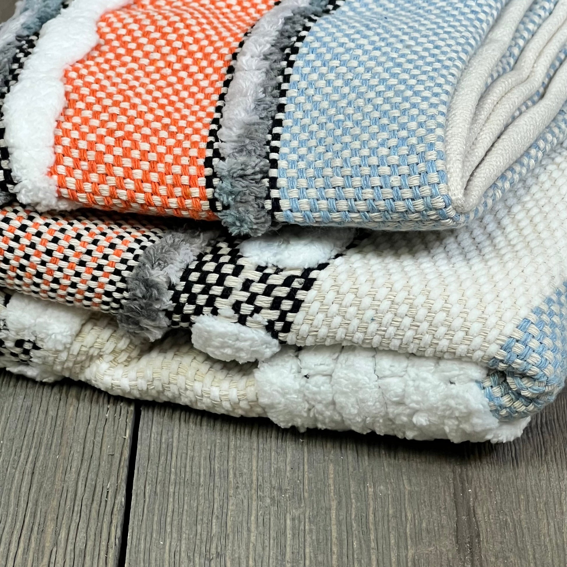 Boho throw pillow covers in orange and blue stripes, showcasing textured chenille fabric for a farmhouse style.