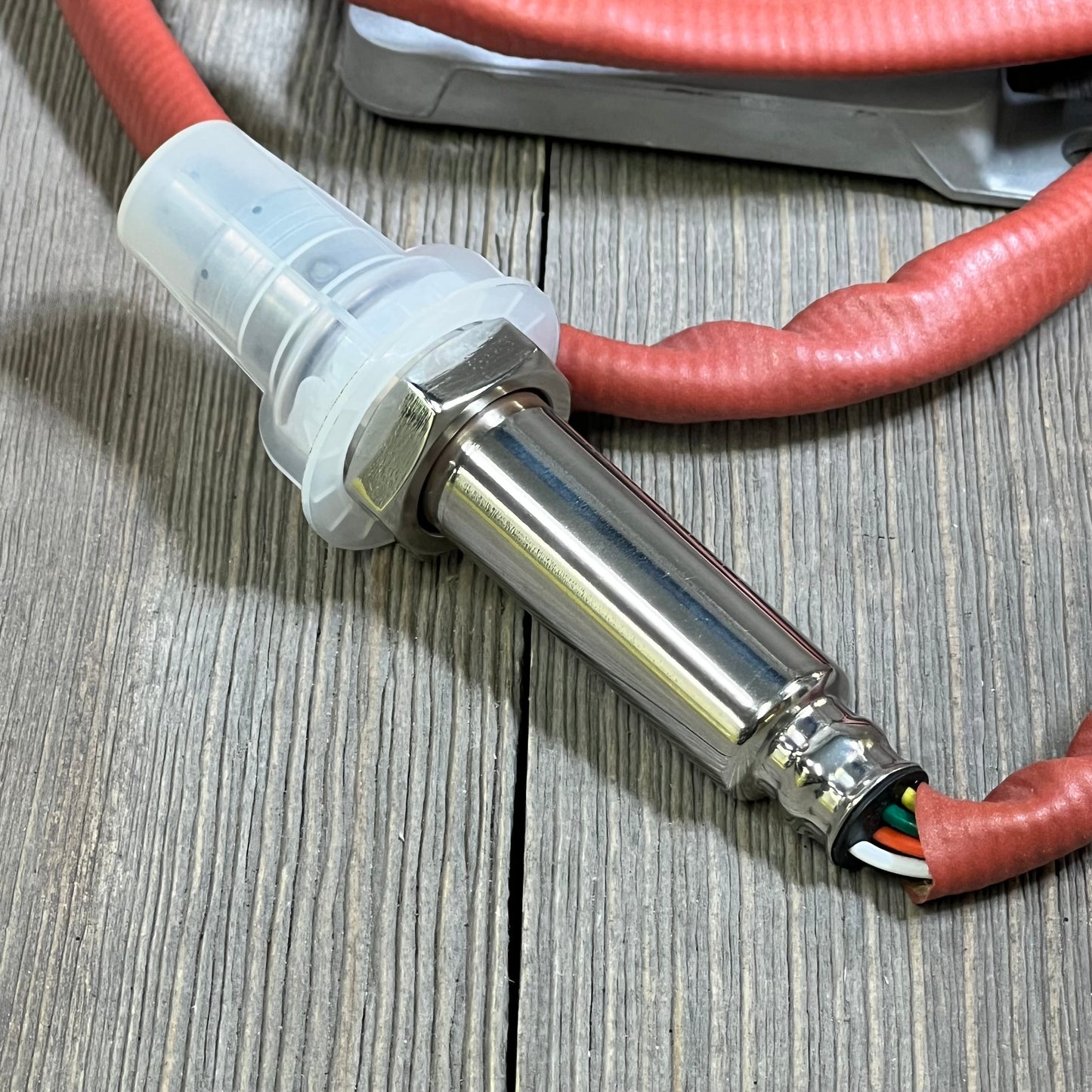 Stainless steel NOx sensor for BMW models, featuring durable red wire and secure connector, enhances emission control.