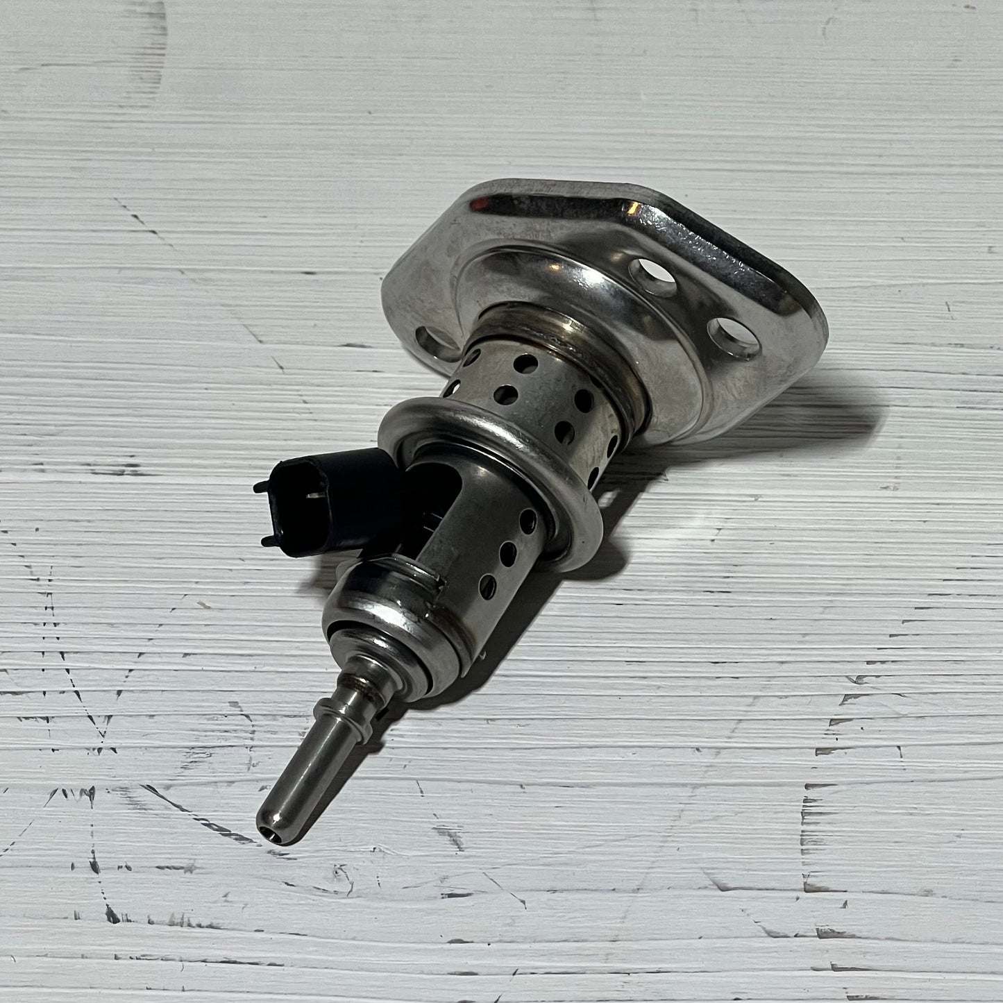 Diesel Exhaust Fluid Injector compatible with Ram and Ford Super Duty trucks, showcasing durable metal design.
