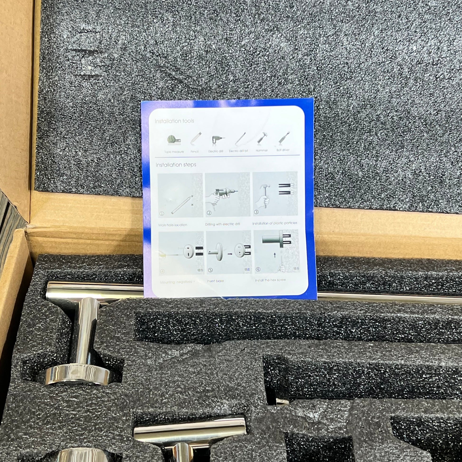 Polished chrome bathroom hardware set in packaging with installation instructions, featuring stainless steel towel bars.