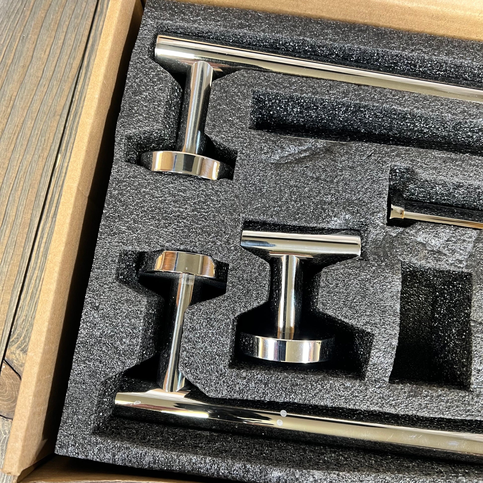 Stainless steel bathroom hardware set in packaging, featuring polished chrome towel bars and accessories.