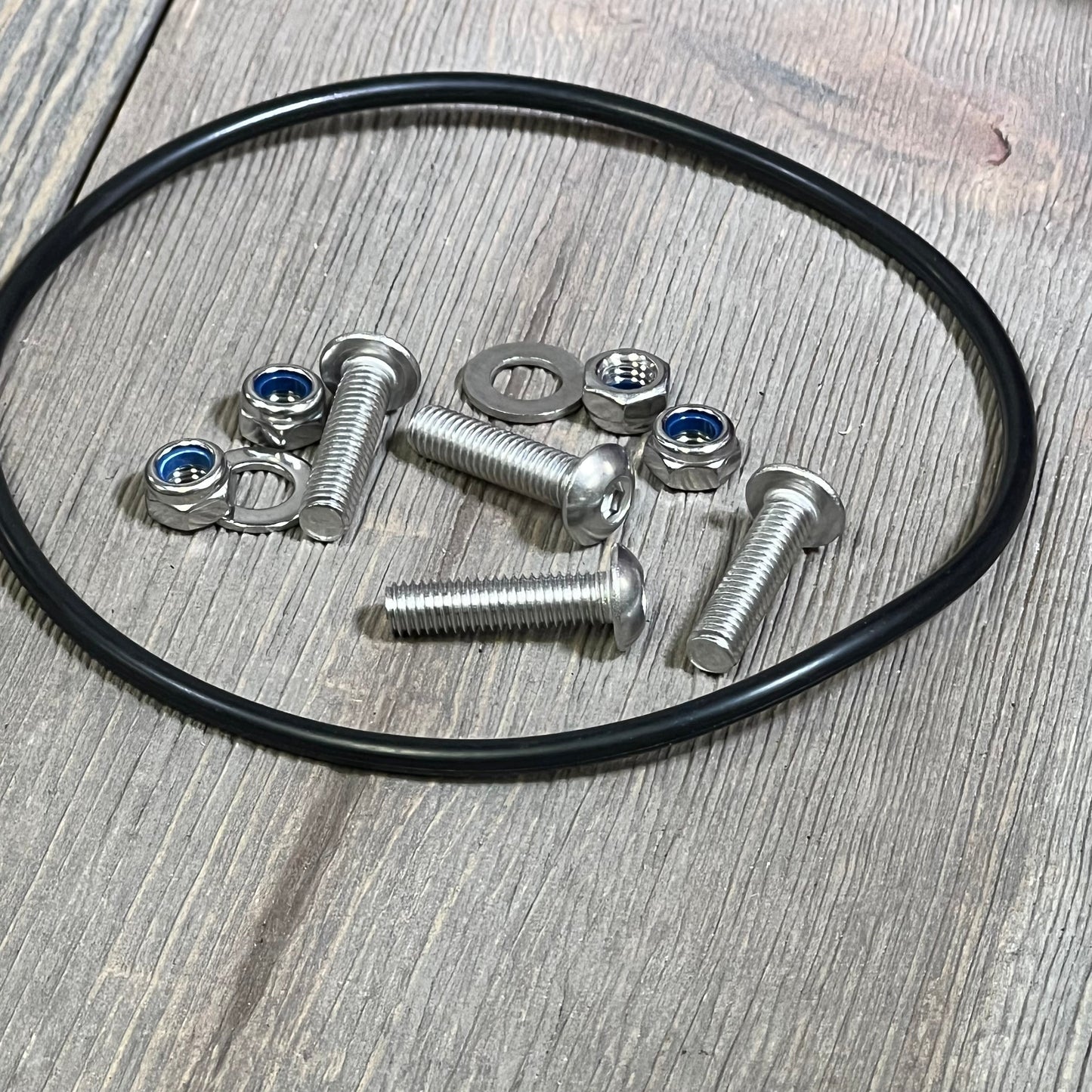 Silver bolts, washers, and nuts included in the Motoparty Engine Air Filter kit for Yamaha YFM700 Raptor, shown with adapter ring.