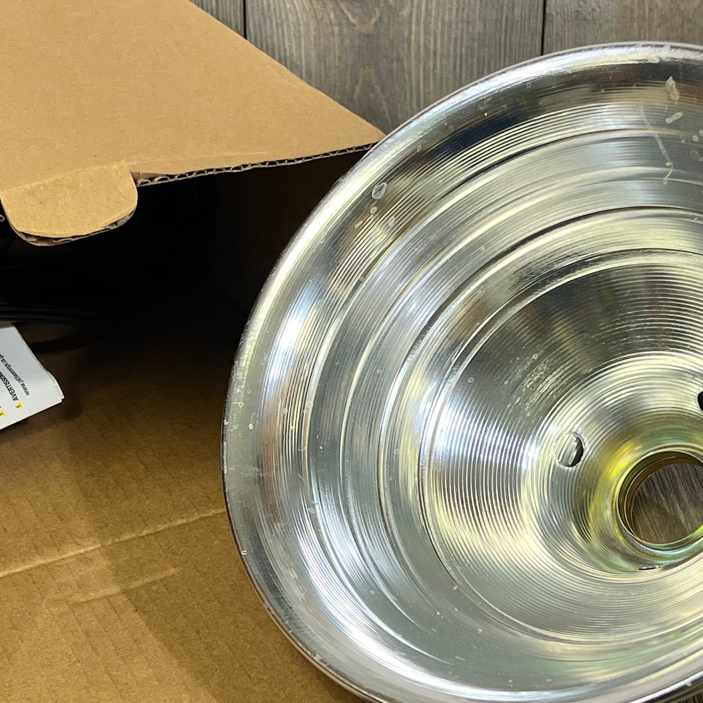 Silver aluminum reflector of the Simple Deluxe Clamp Lamp, showcasing its durable design and wide light distribution.