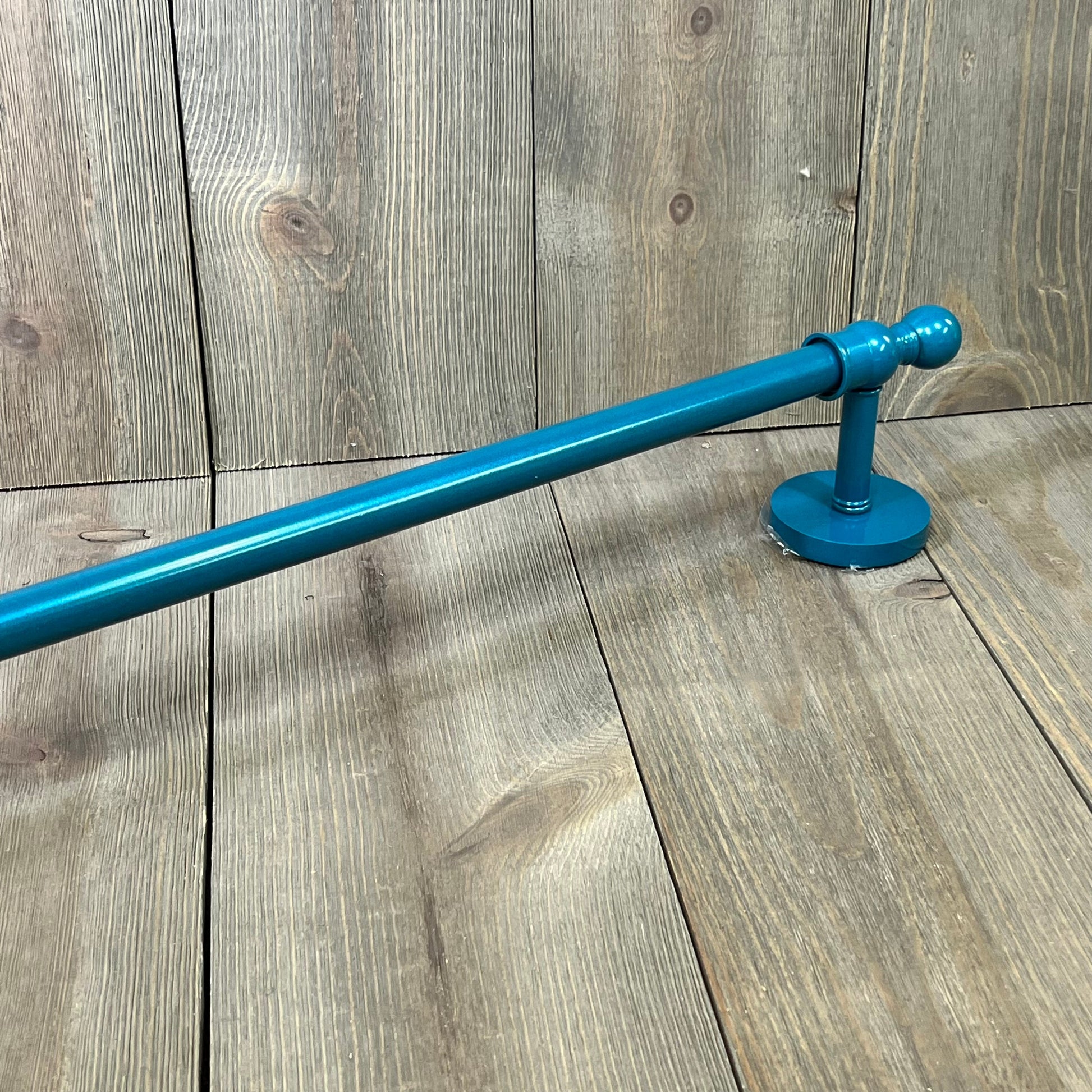 Teal 30-inch towel bar from Allied Brass Skyline Collection, featuring sleek design and durable finish, on wooden background.
