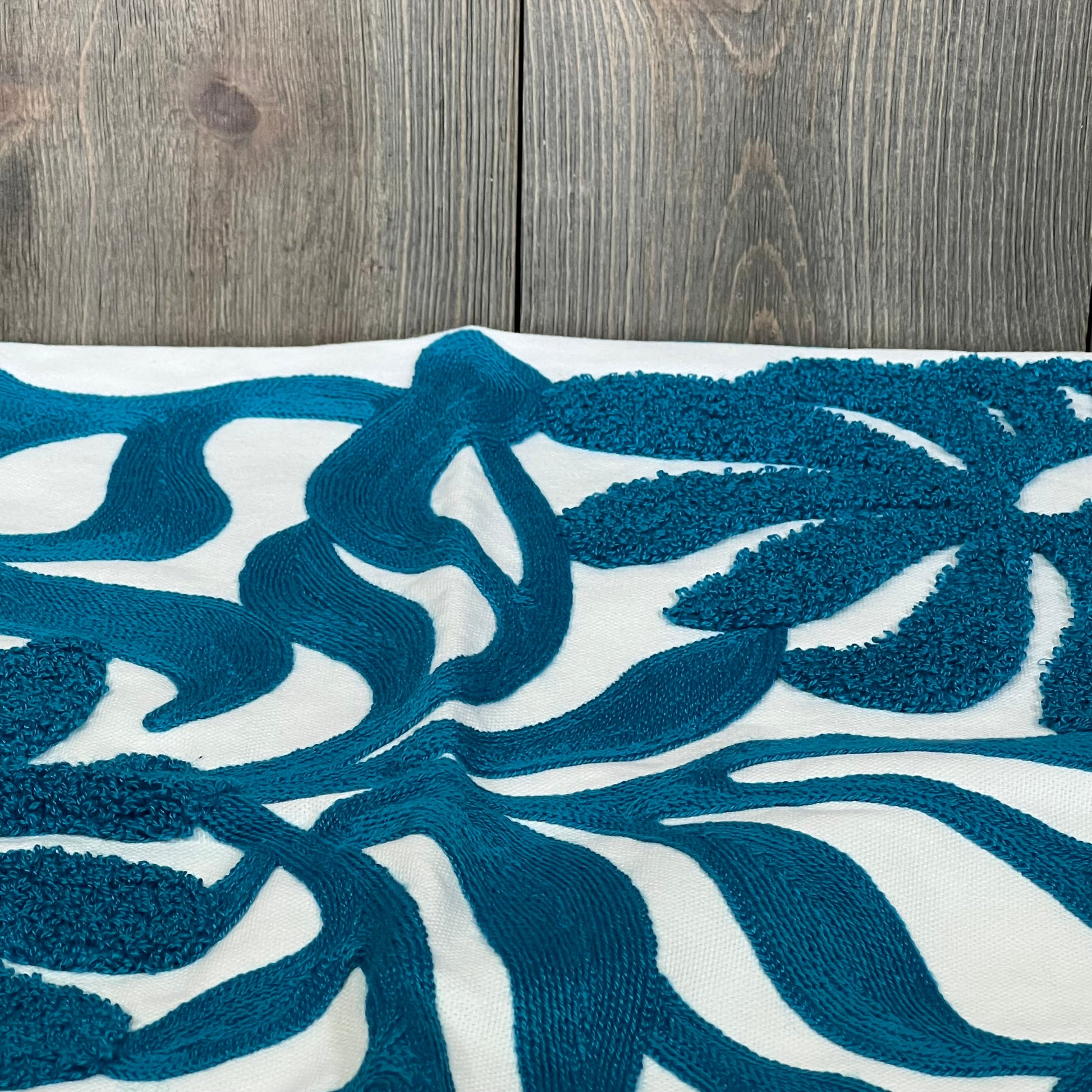 Teal blue floral embroidered throw pillow cover with boho tufted design, perfect for enhancing your living room decor.