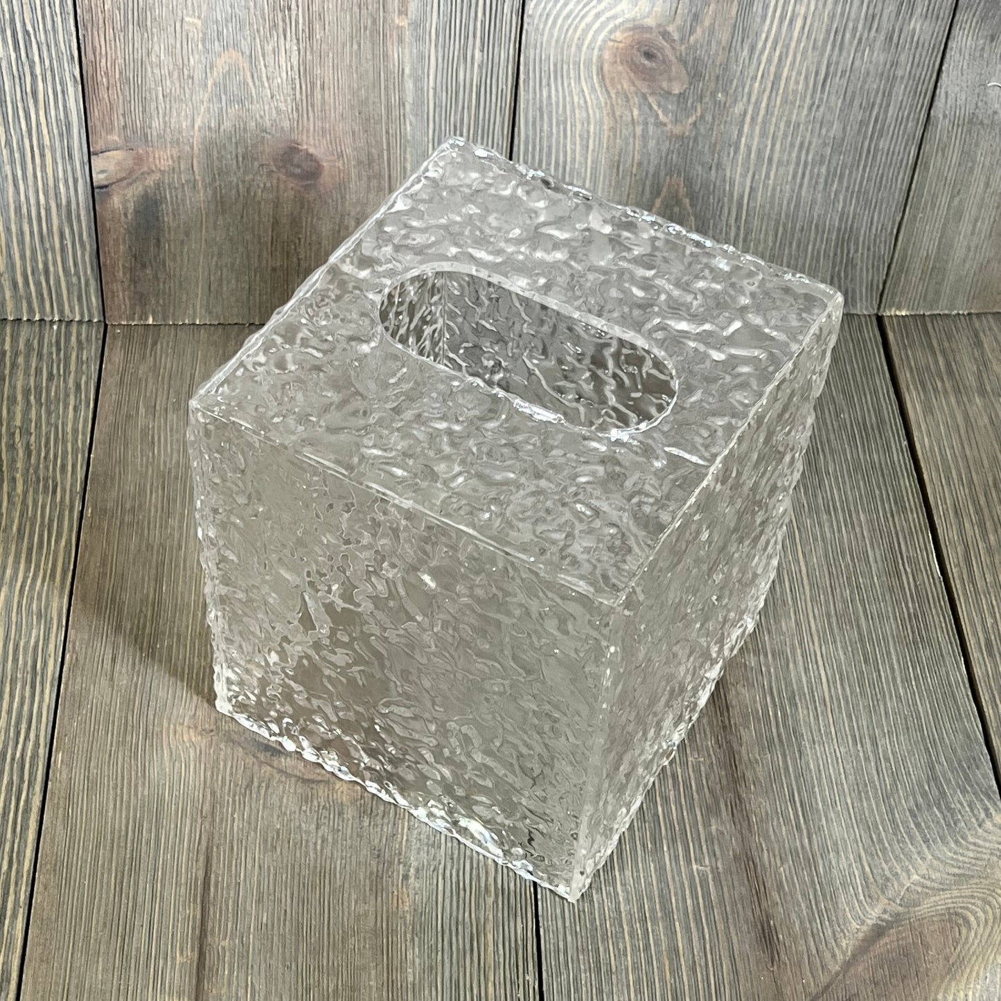 Clear acrylic tissue holder with ripple texture, perfect for modern bathroom decor. Open bottom for easy refill.