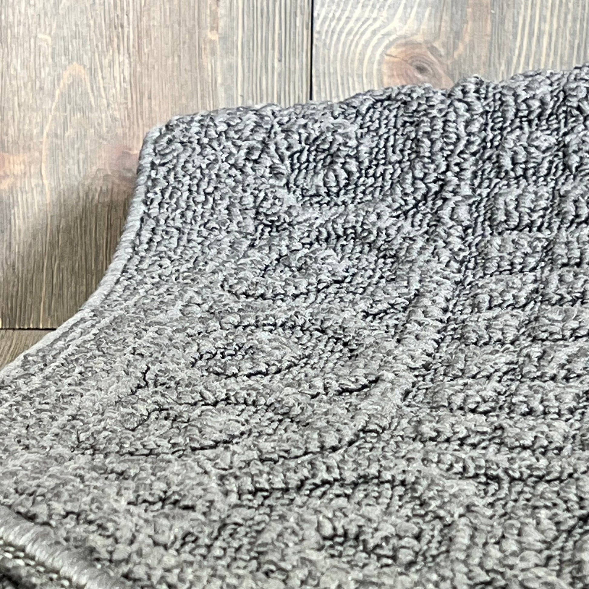 Close-up of grey 32x20 inch anti-fatigue kitchen rug, showcasing textured polypropylene surface and cushioned design.