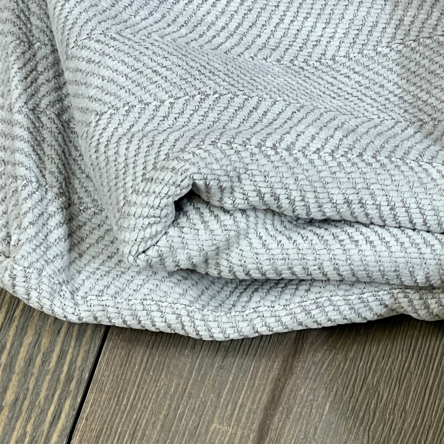Luxurious light grey chenille pillow cover with elegant design, perfect for farmhouse decor and cozy living room ambiance.
