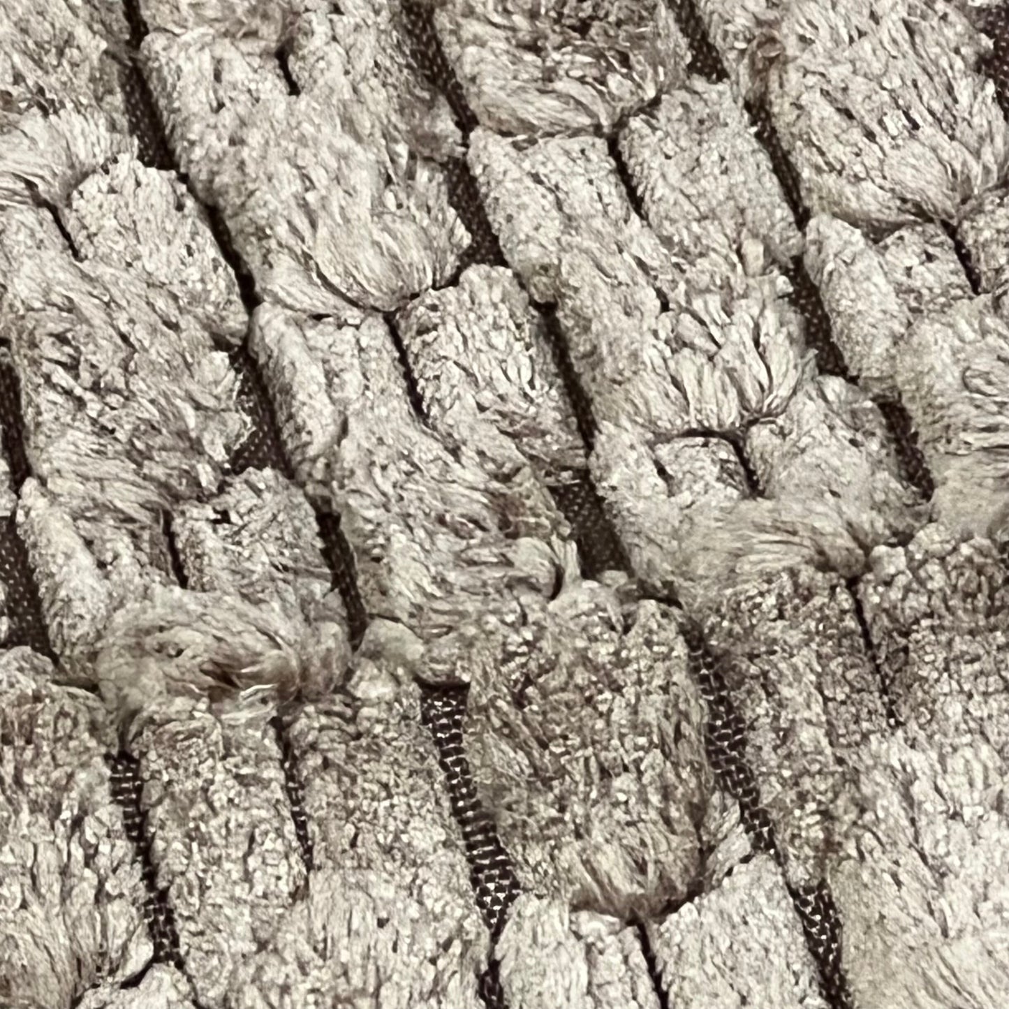 Textured close-up of light brown corduroy fabric on Kevin Textile throw pillow cover, showcasing rustic boho design.