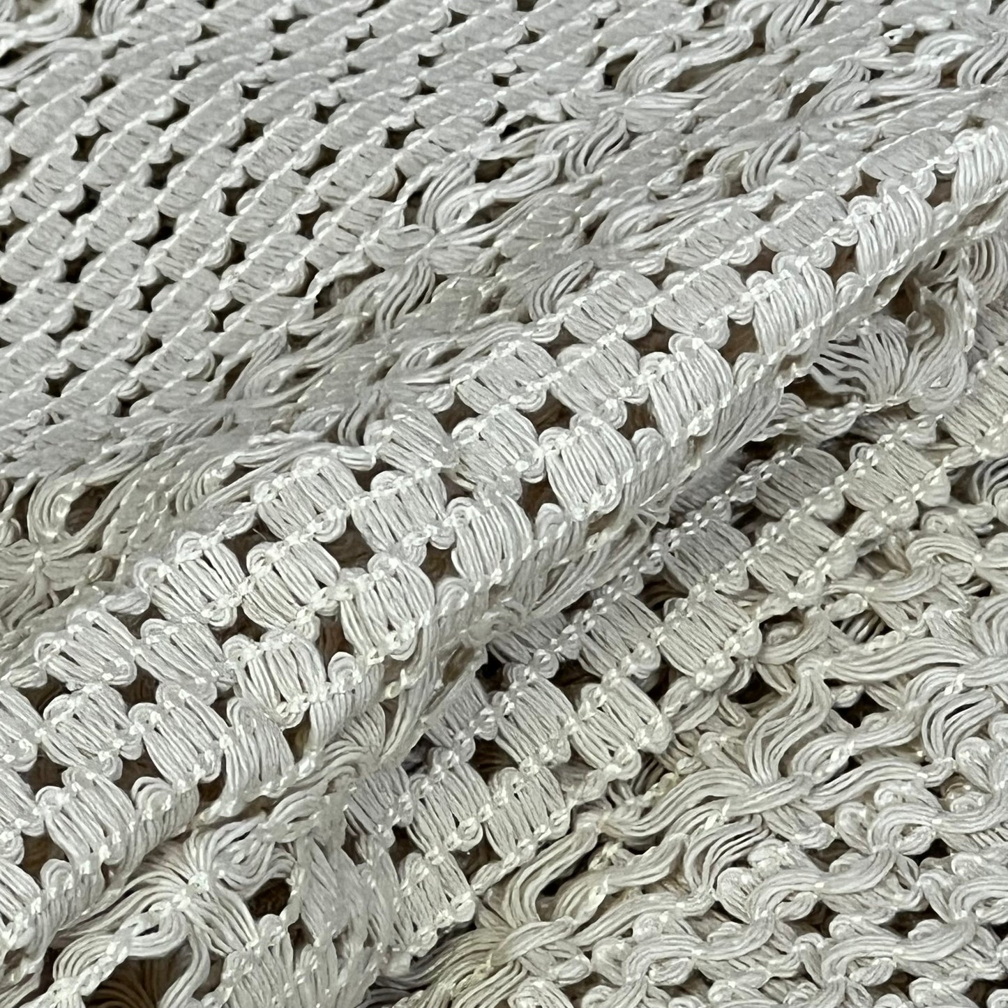 Cream beige macrame table mat close-up, showcasing intricate cotton linen weave and tassel details for farmhouse decor.