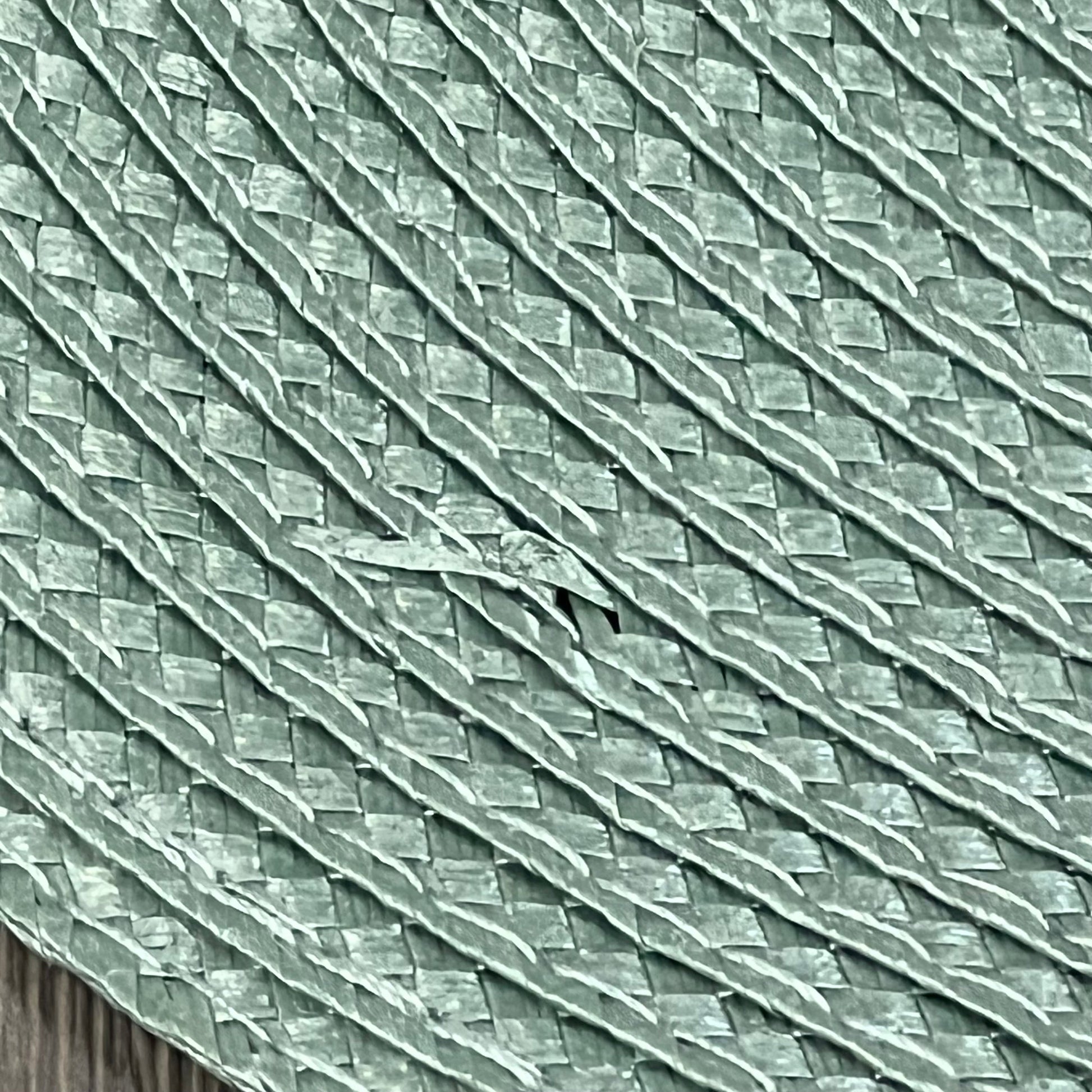 Close-up of AHHFSMEI sage green woven vinyl placemat texture, showcasing durable, non-slip, and heat-resistant design.