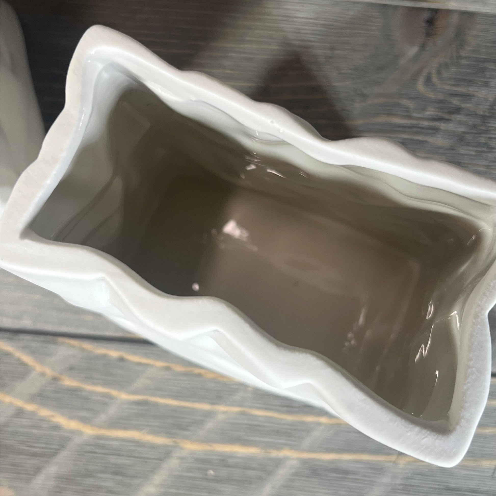 Top view of Crinkle Paper Bag Ceramic Vase with wavy edges and crème finish.