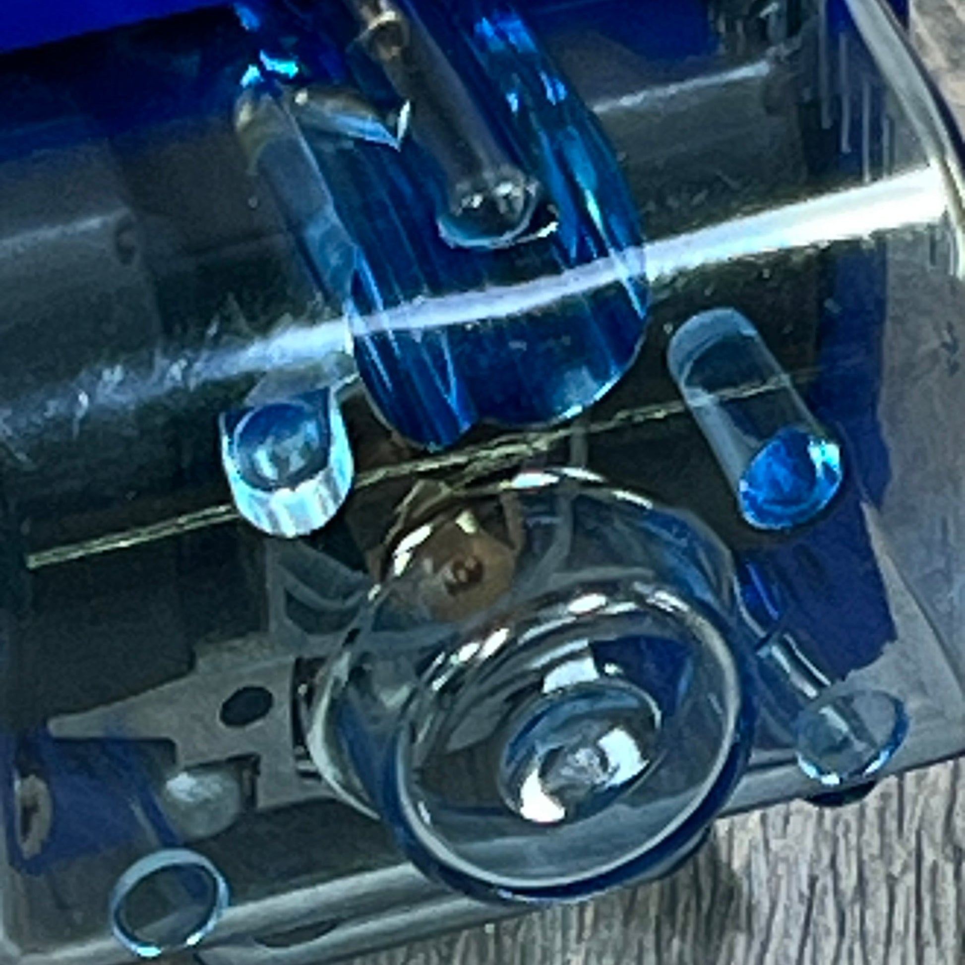 Close-up of blue float bowl on Universal PWK Carburetor, designed for 2T 4T engines in motorcycles and ATVs.