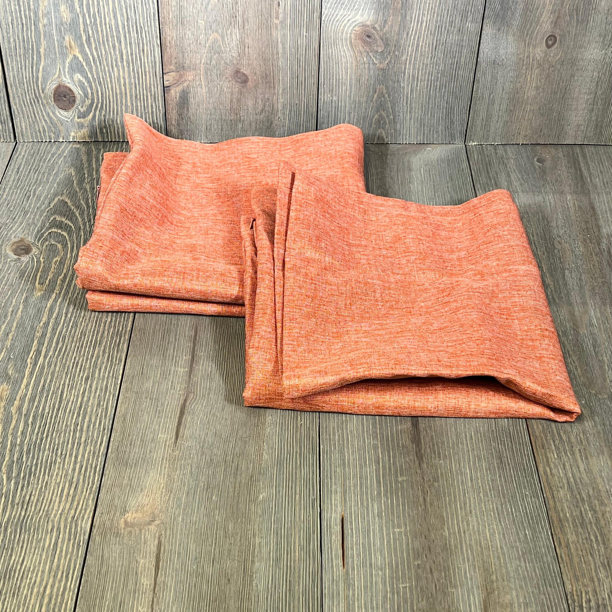 Coral red outdoor waterproof pillow covers on wooden background, perfect for farmhouse decor. Set of 2, 18x18 inches.