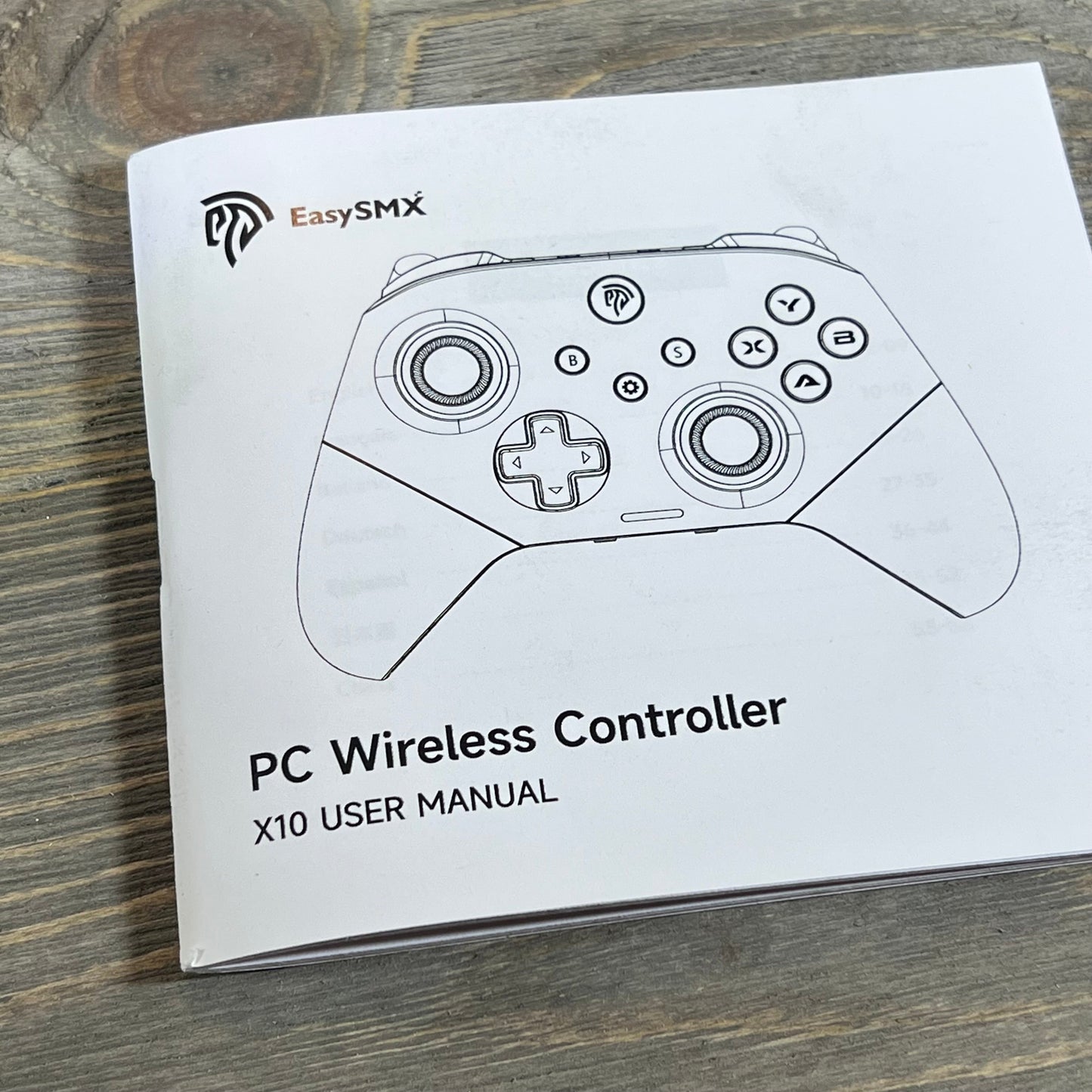 User manual cover for EasySMX X10 Wireless Bluetooth Controller on a wooden surface.