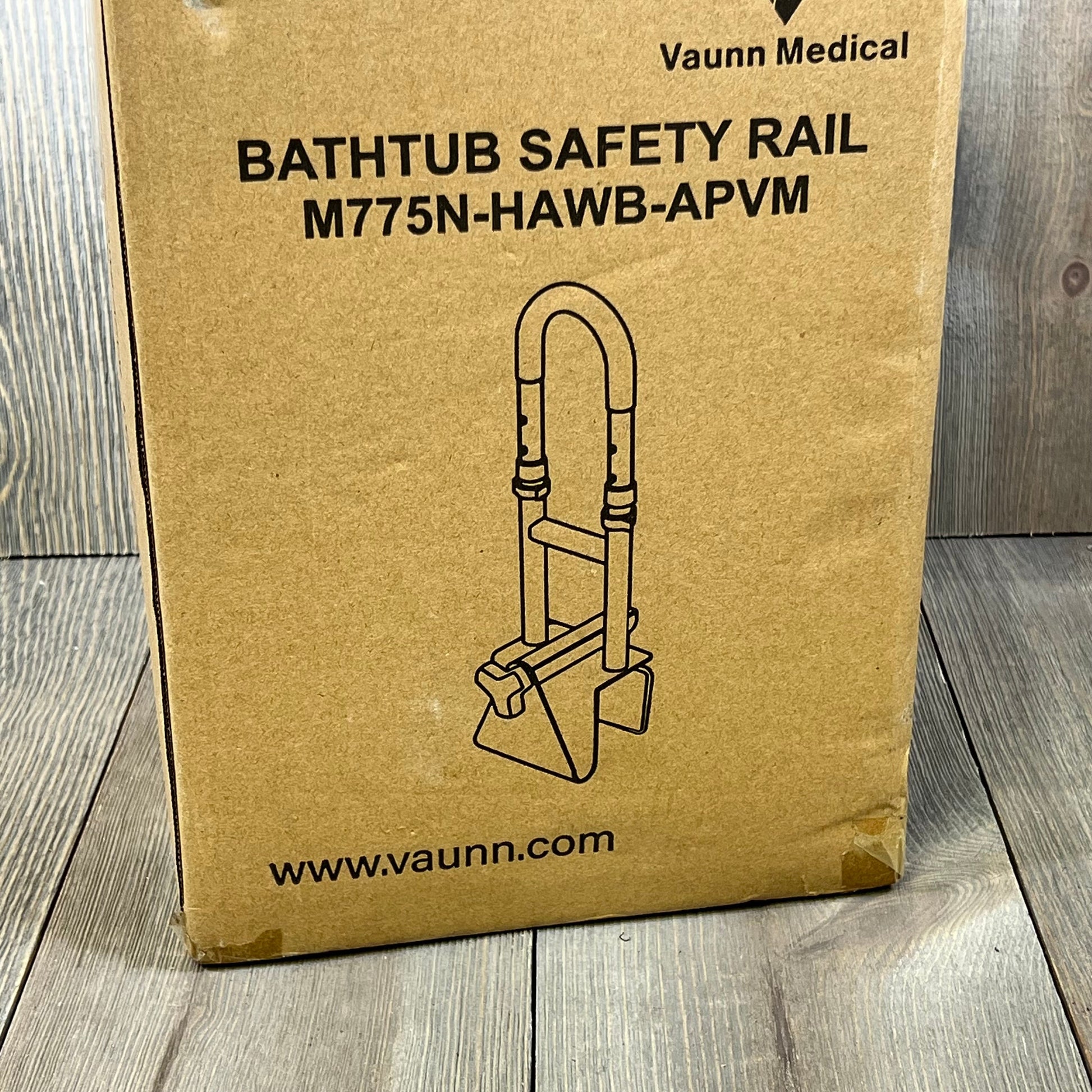 Cardboard packaging of Vaunn Medical Bathtub Handle Grab Bar, displaying product illustration and model number M775N-HAWB-APVM.